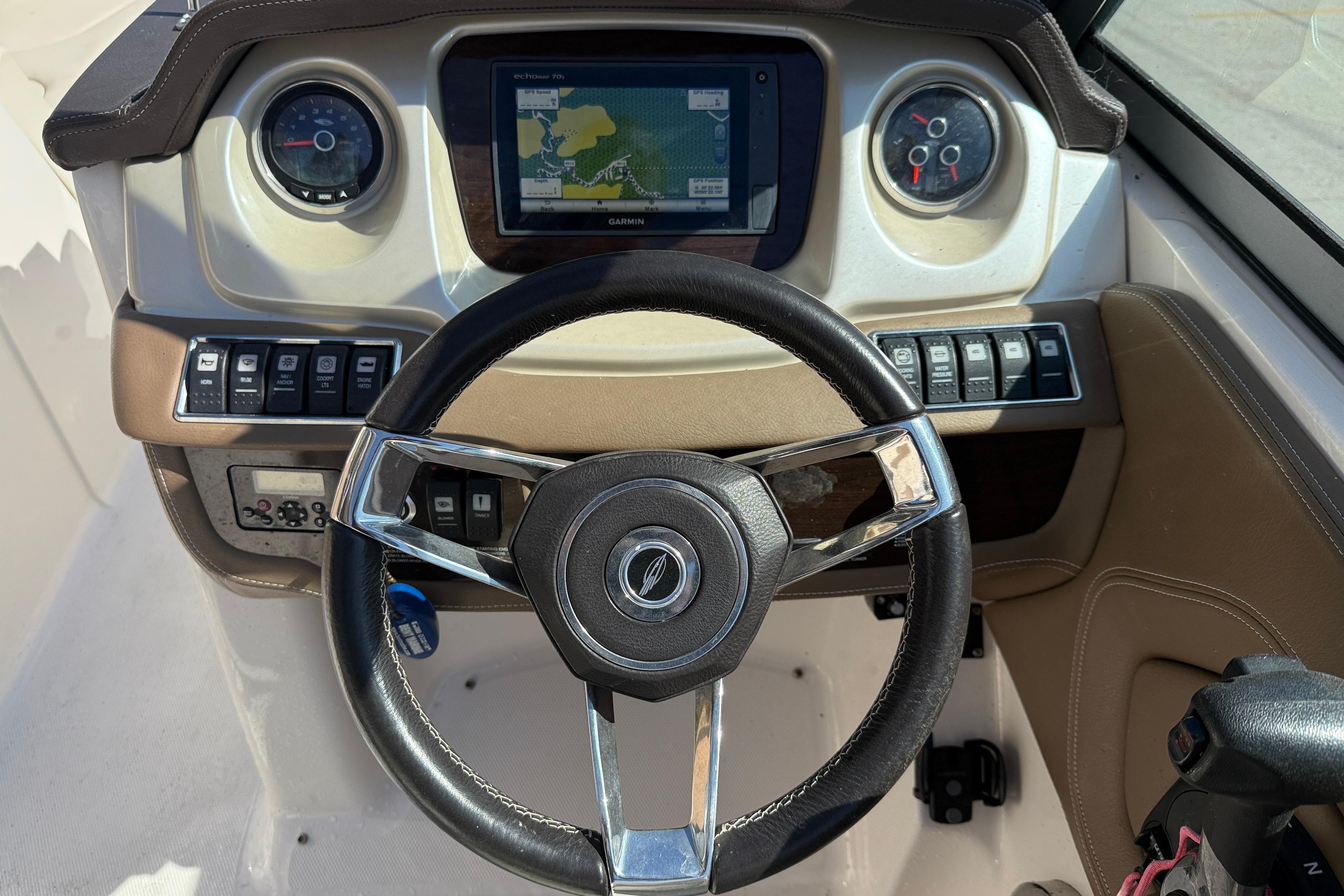 Steering console of 2014 Chaparral 264 Sunesta with GPS and control panel.