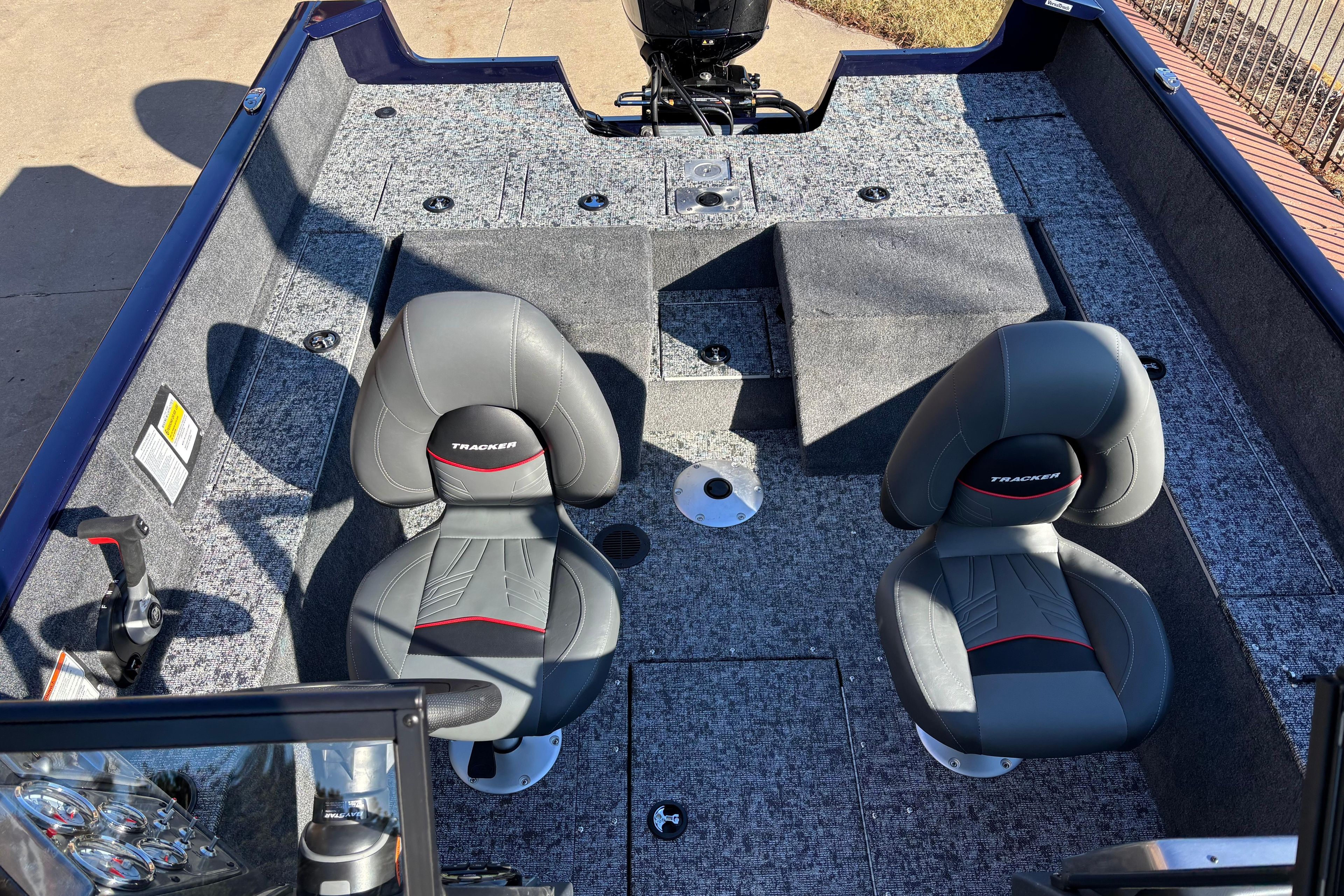 2026 Tracker Pro Guide V-175 Combo boat interior with two gray seats and carpeted flooring.