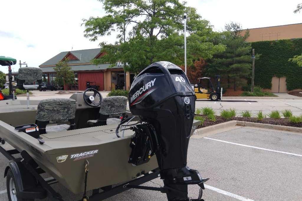 Tracker Grizzly 1754 SC with Mercury 40 HP engine on a trailer in a parking lot.