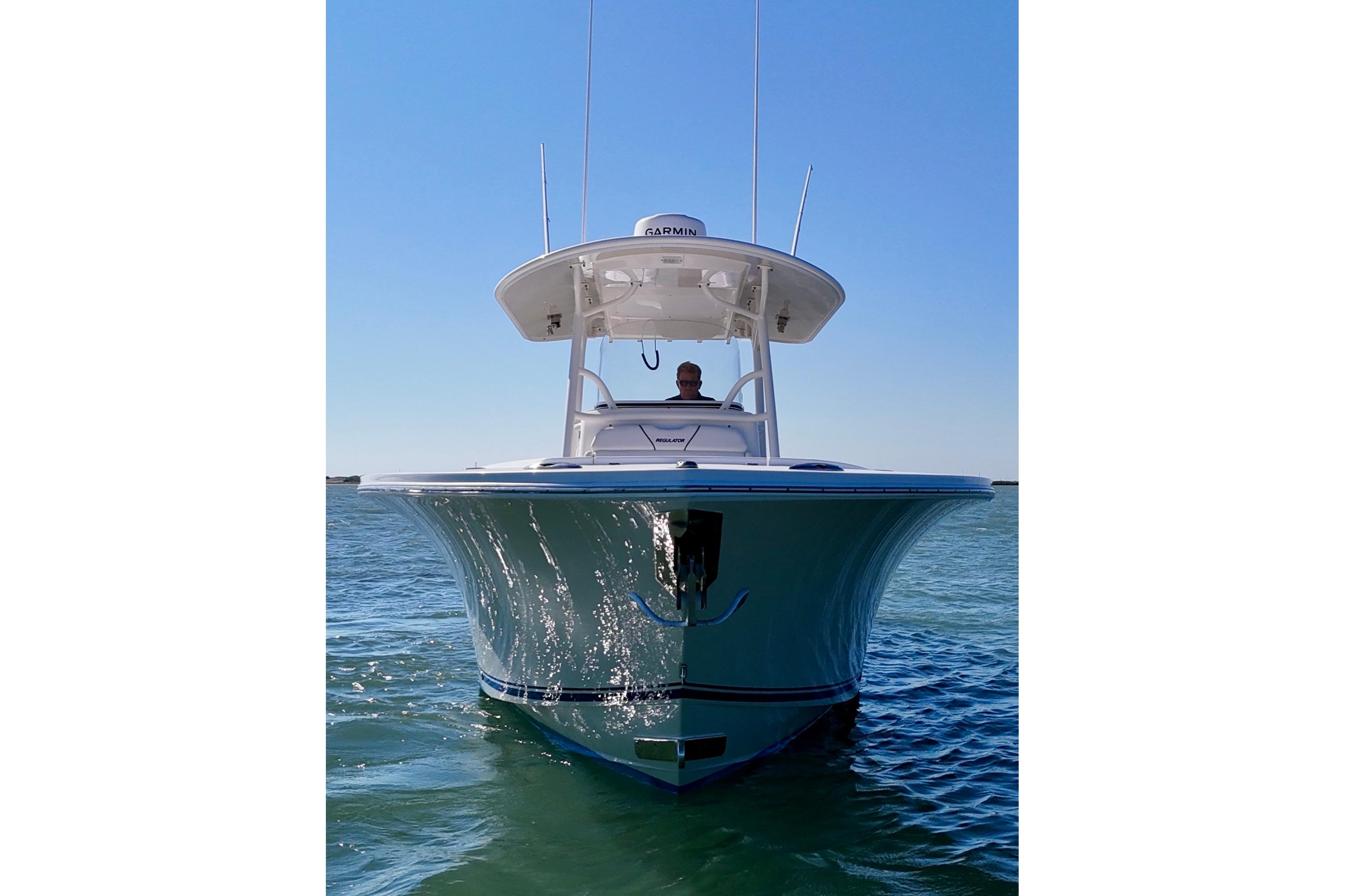2016 Regulator 28 Forward Seating boat on calm water, front view.