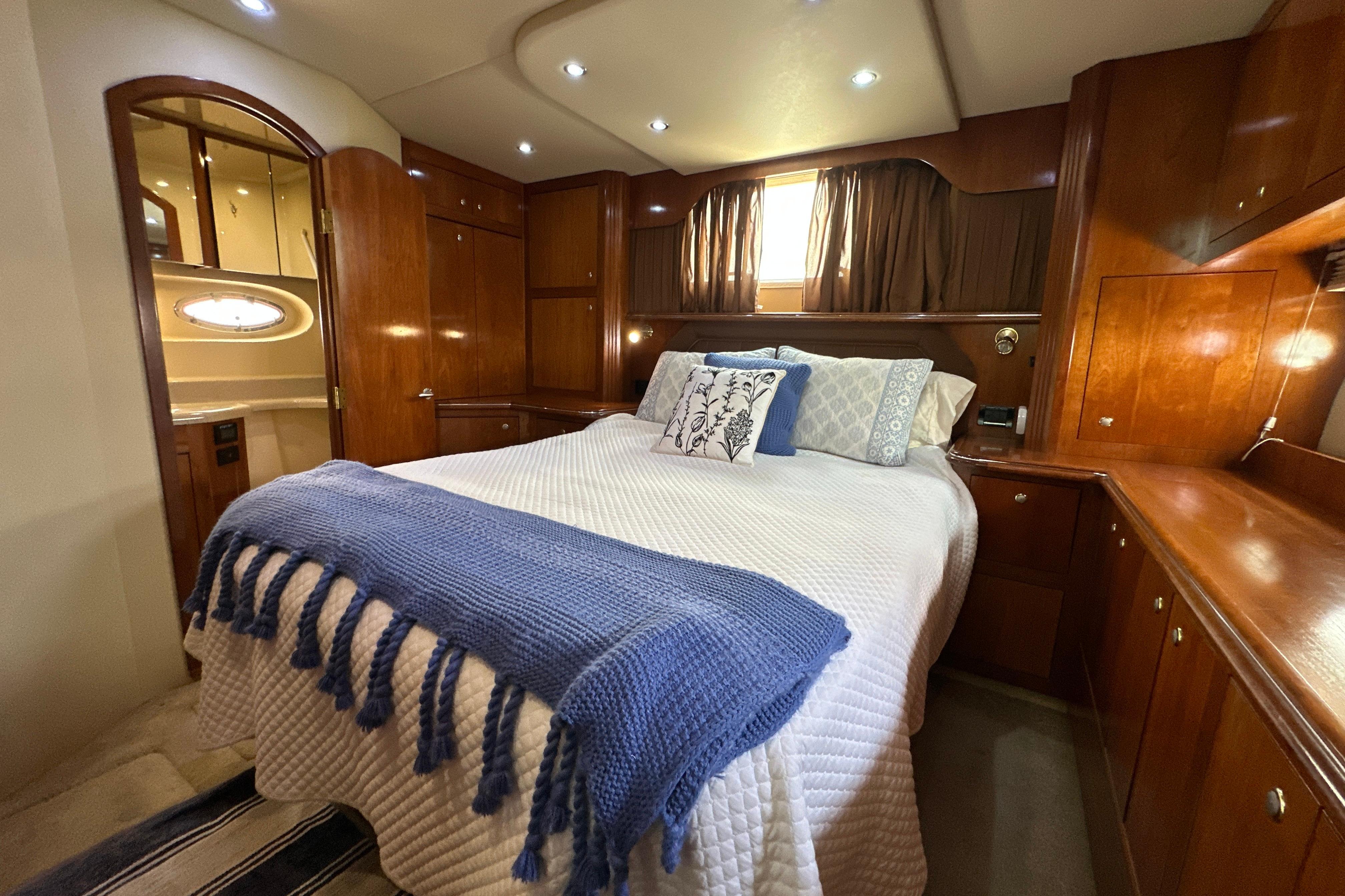 Luxurious cabin interior of 2004 Cruisers Yachts 405 Express Motoryacht with elegant wood finish.