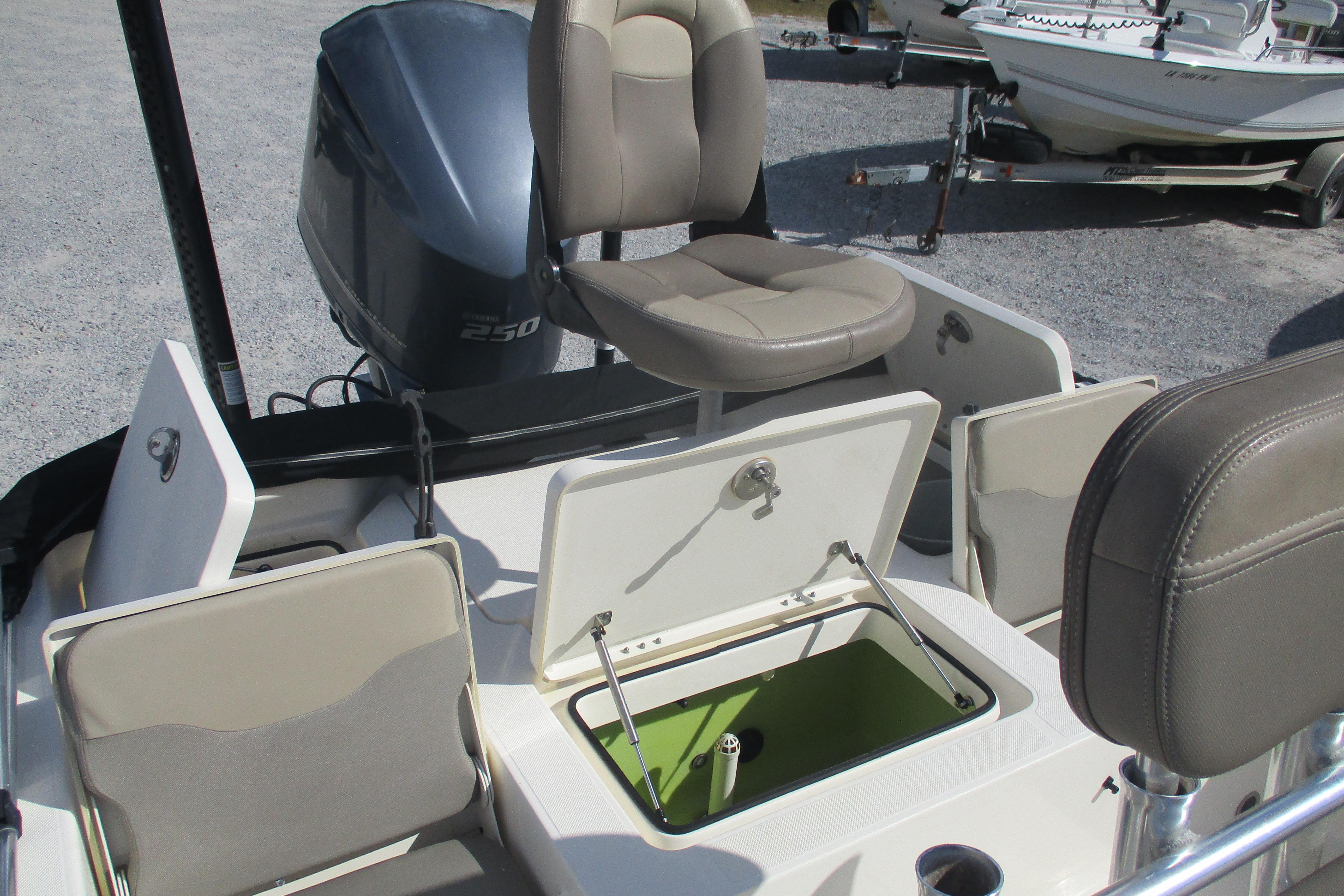 2014 Skeeter SX240 boat interior with open storage compartments and seating.
