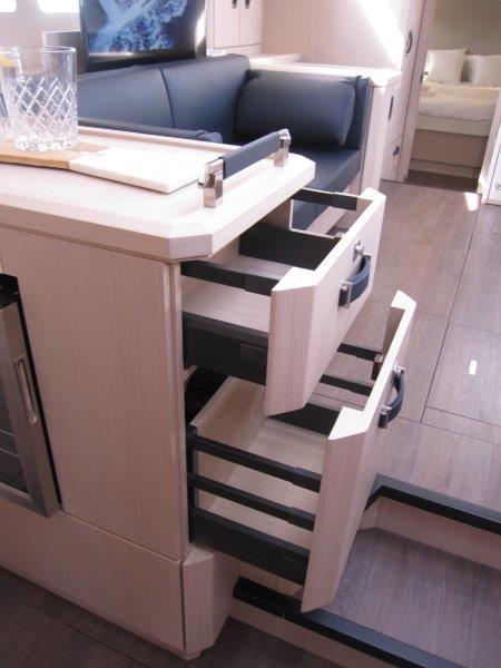 Modern interior of 2024 Jeanneau 60 yacht with open drawers.