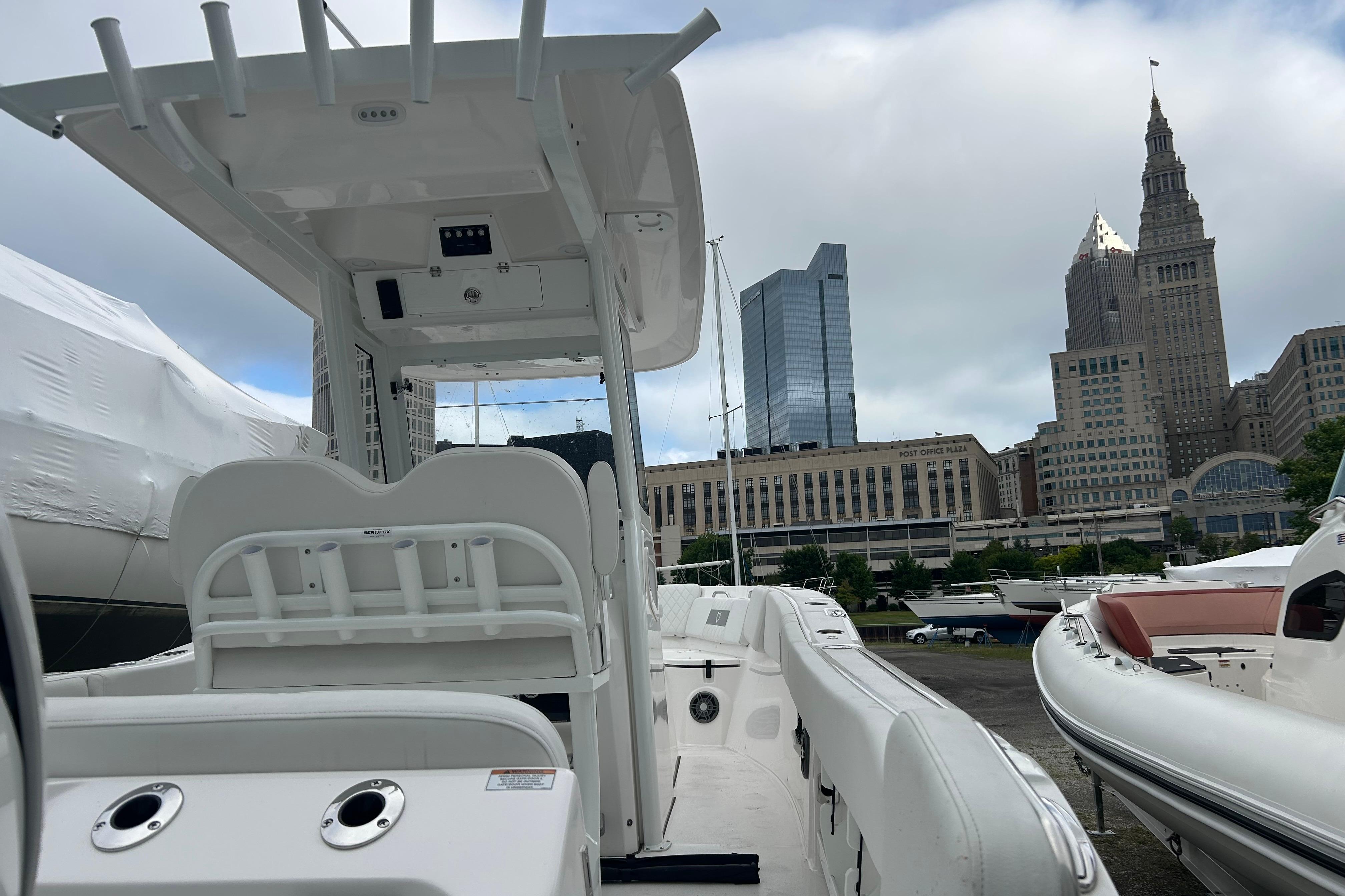 2026 Sea Fox 268 Commander boat docked with city skyline in background.