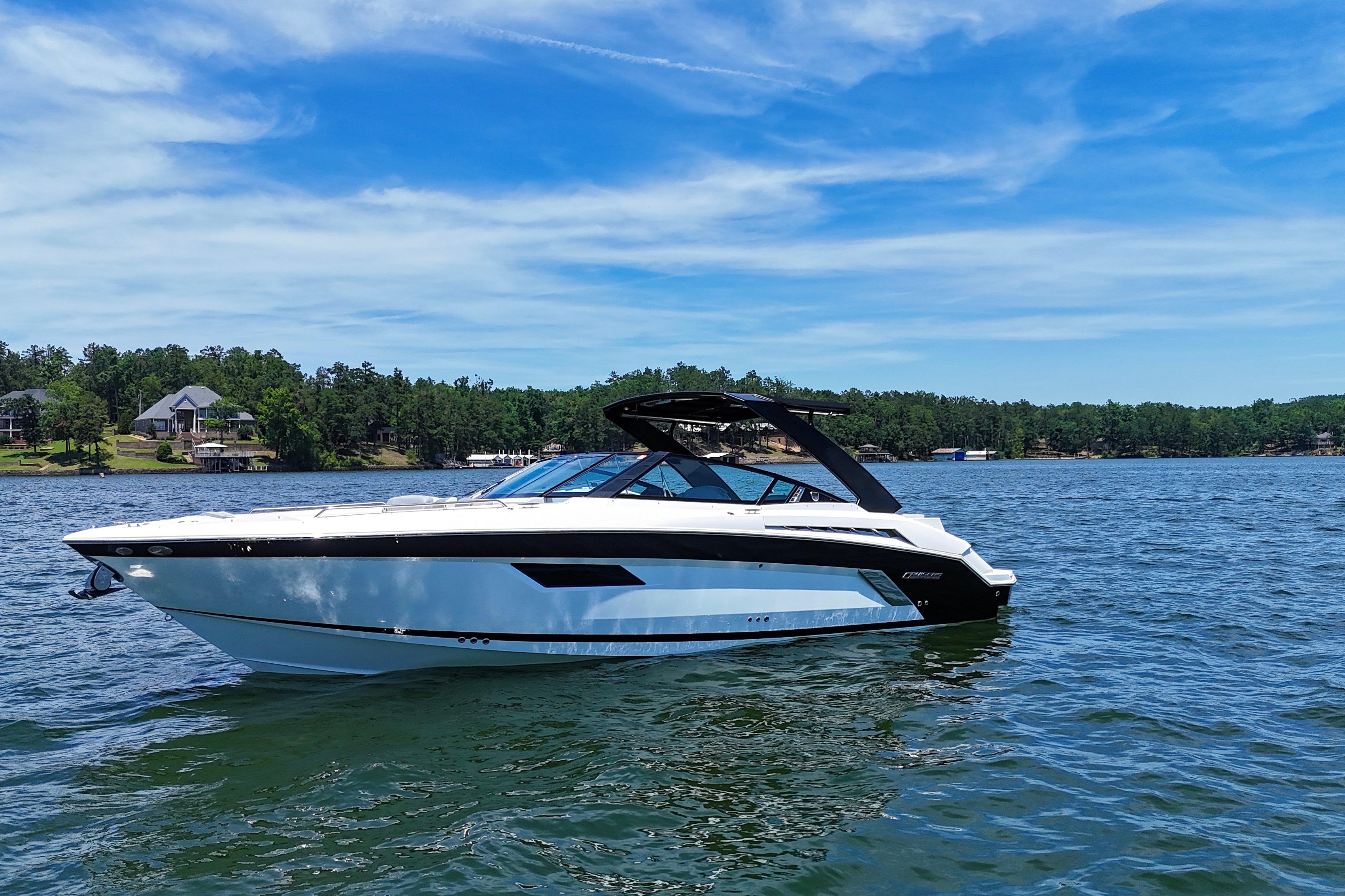 2017 Cruisers Yachts 338 Bow Rider on a scenic lake under a clear blue sky.