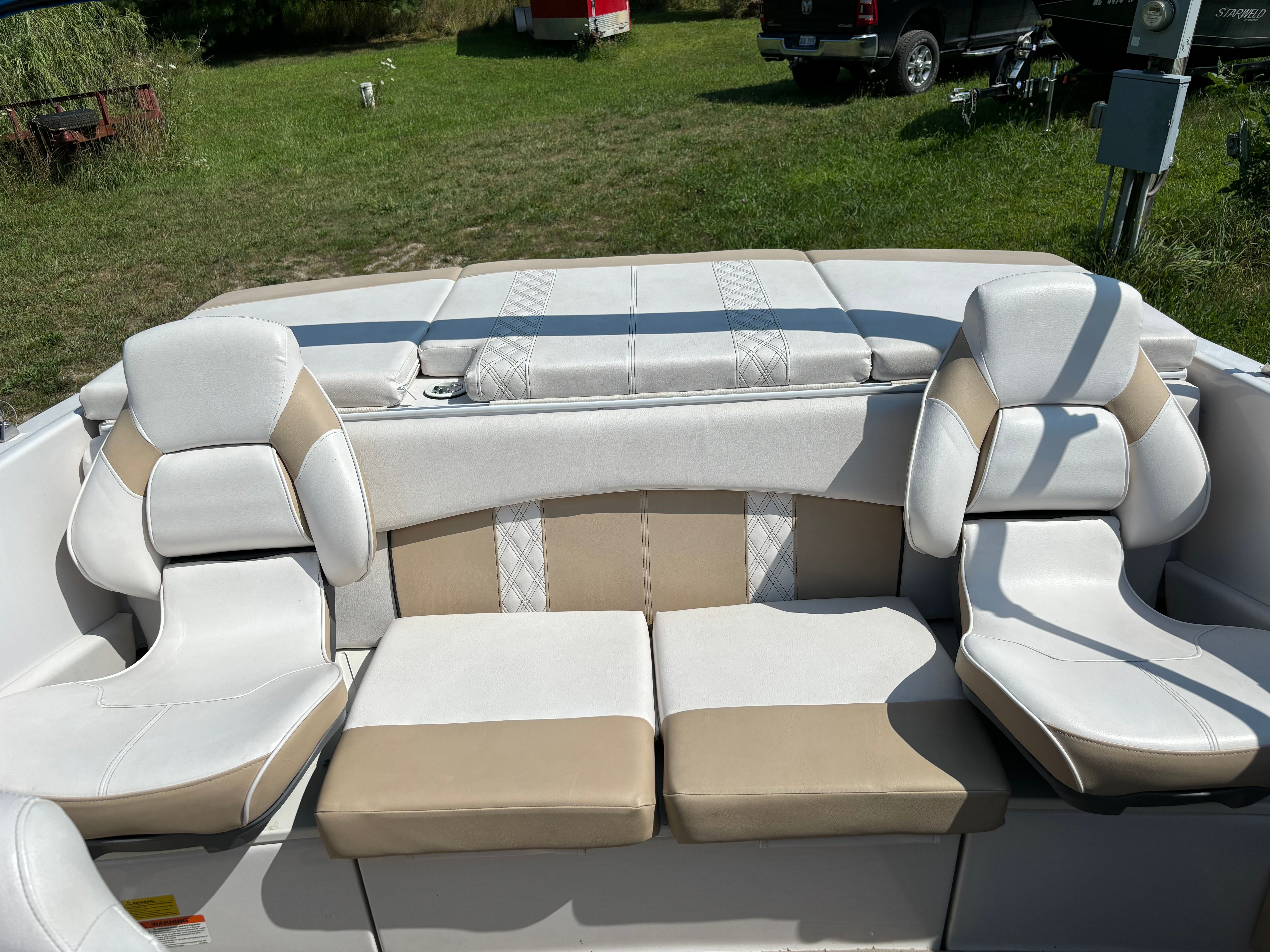 Interior view of a Glastron boat with beige and white seating.