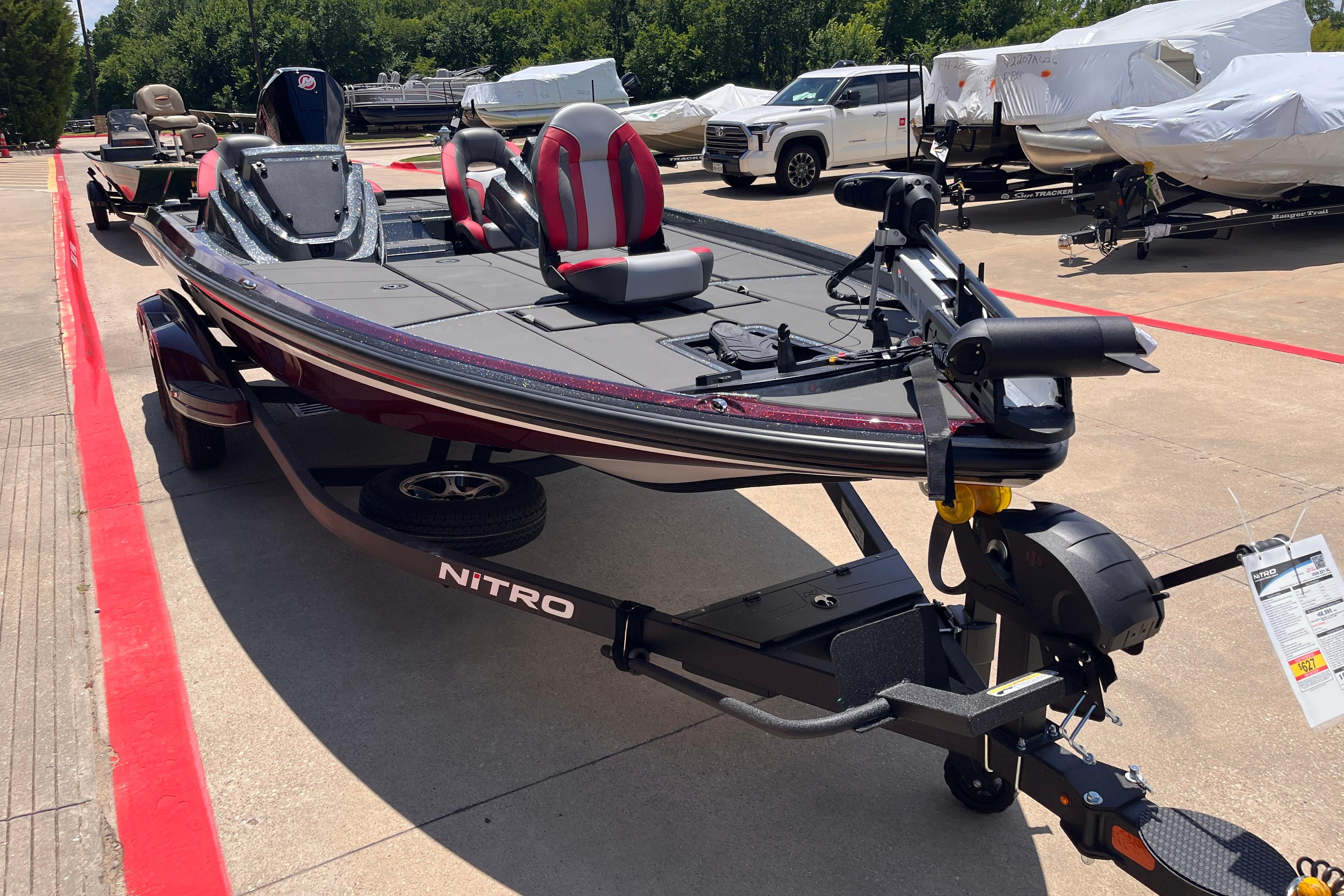 2026 Nitro Z21 XL boat on trailer, parked outdoors, showcasing sleek design and modern features.