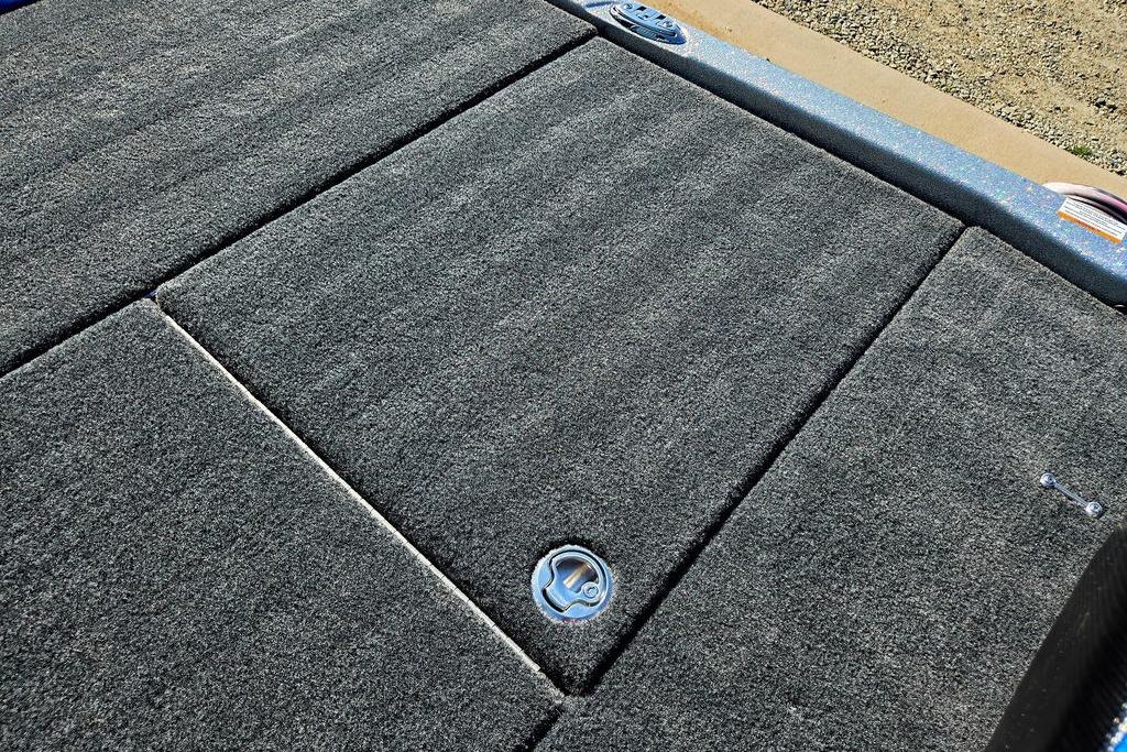 Carpeted deck of 2026 Skeeter ZXE20 boat with storage compartments.