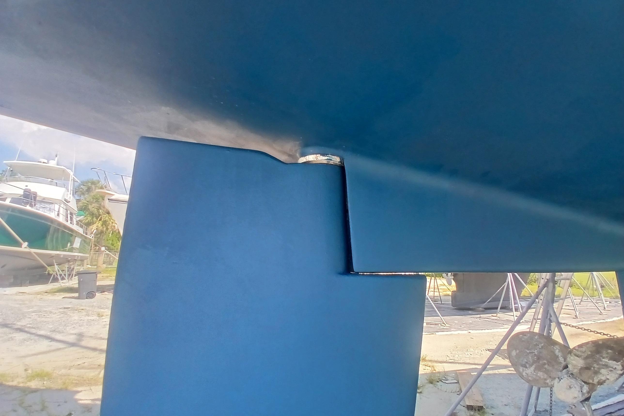 Close-up of a 1995 Catalina 42 MkII sailboat keel and rudder in a boatyard.