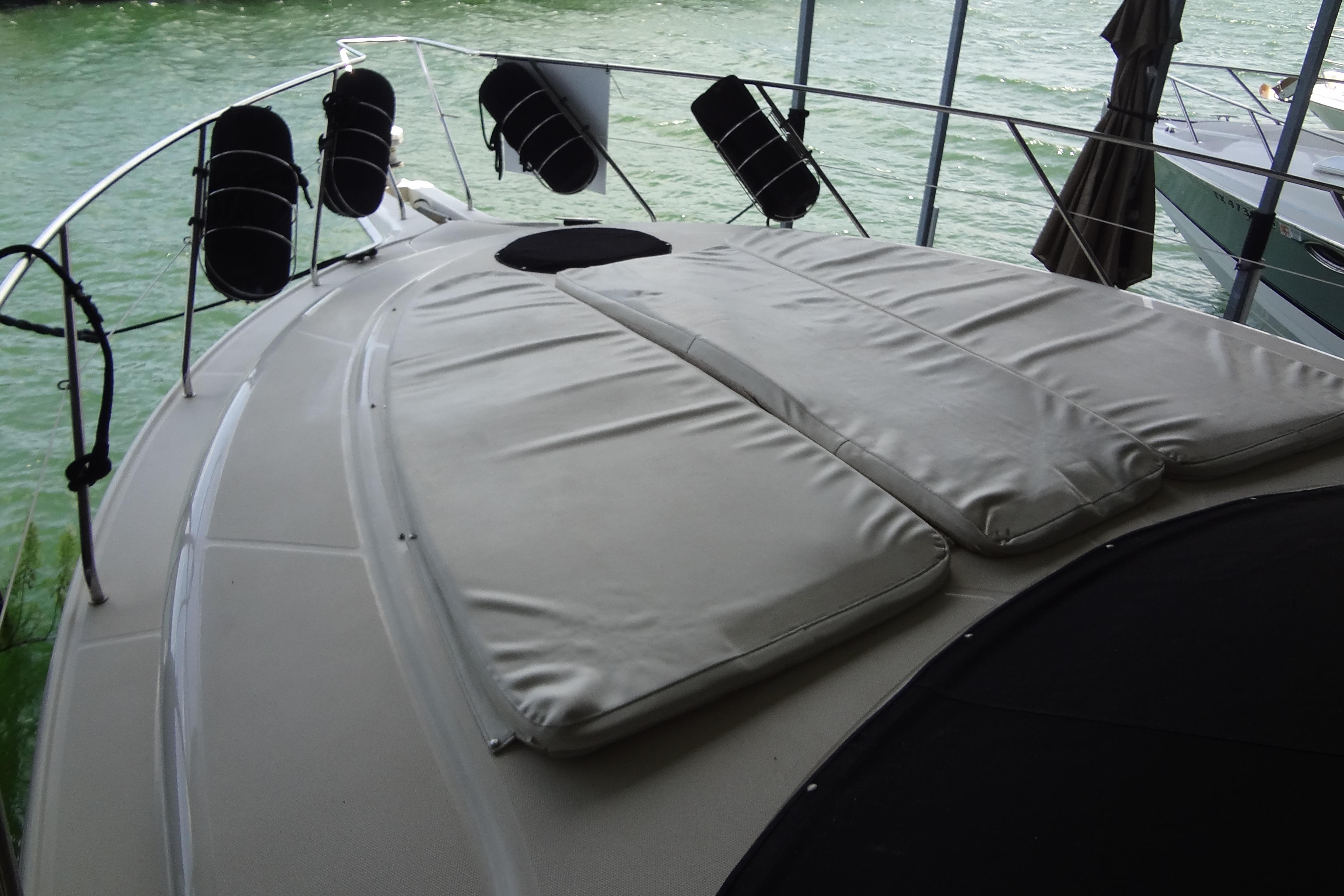 2005 Silverton 34 Convertible yacht deck with cushioned seating and water view.