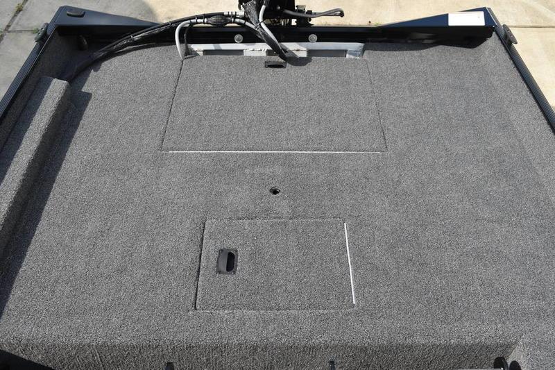 2025 Lowe Skorpion 17 boat deck with carpeted surface and storage compartments.