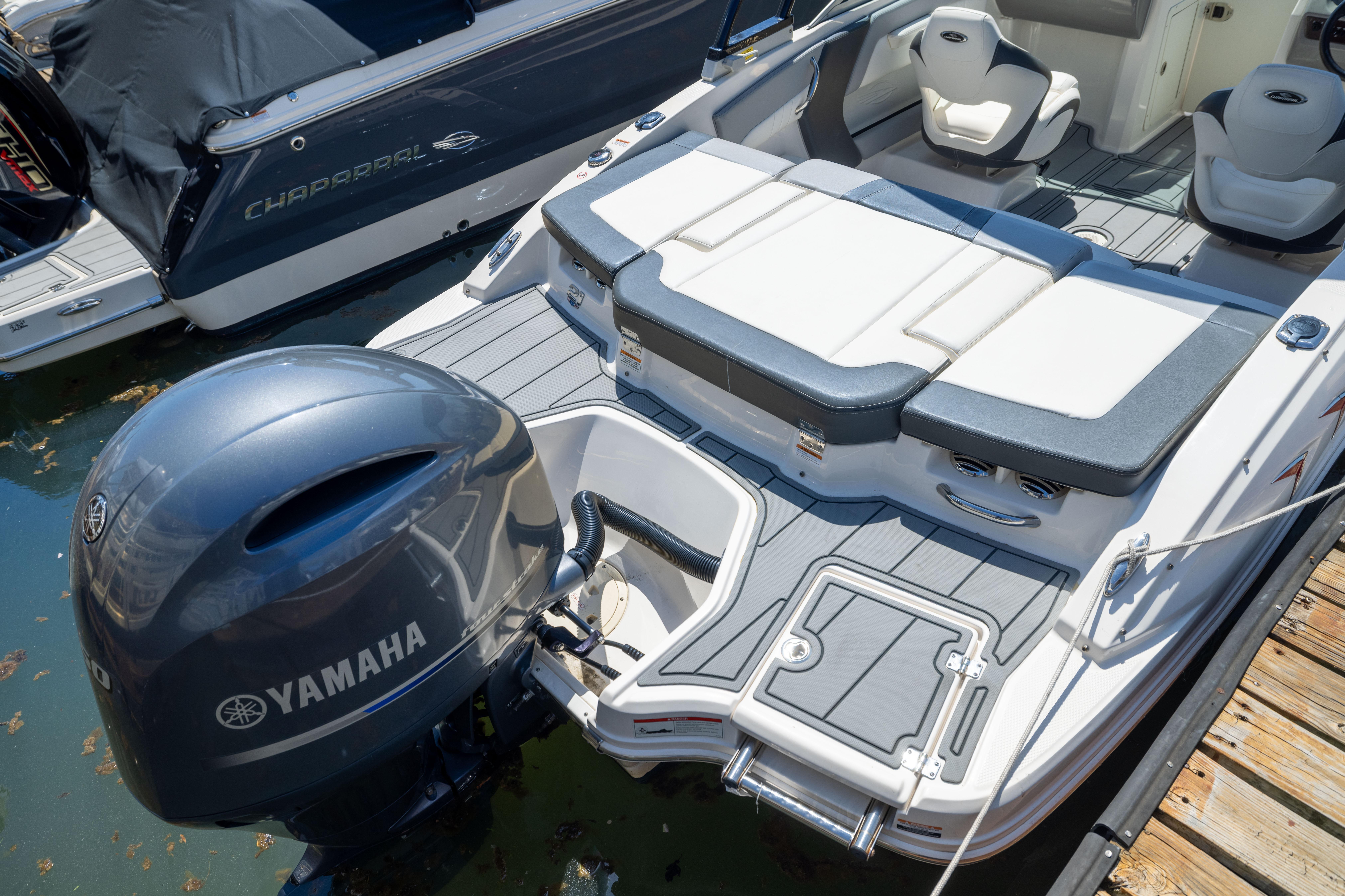 2022 Chaparral 21 SSi OB boat with Yamaha outboard engine, docked on water.