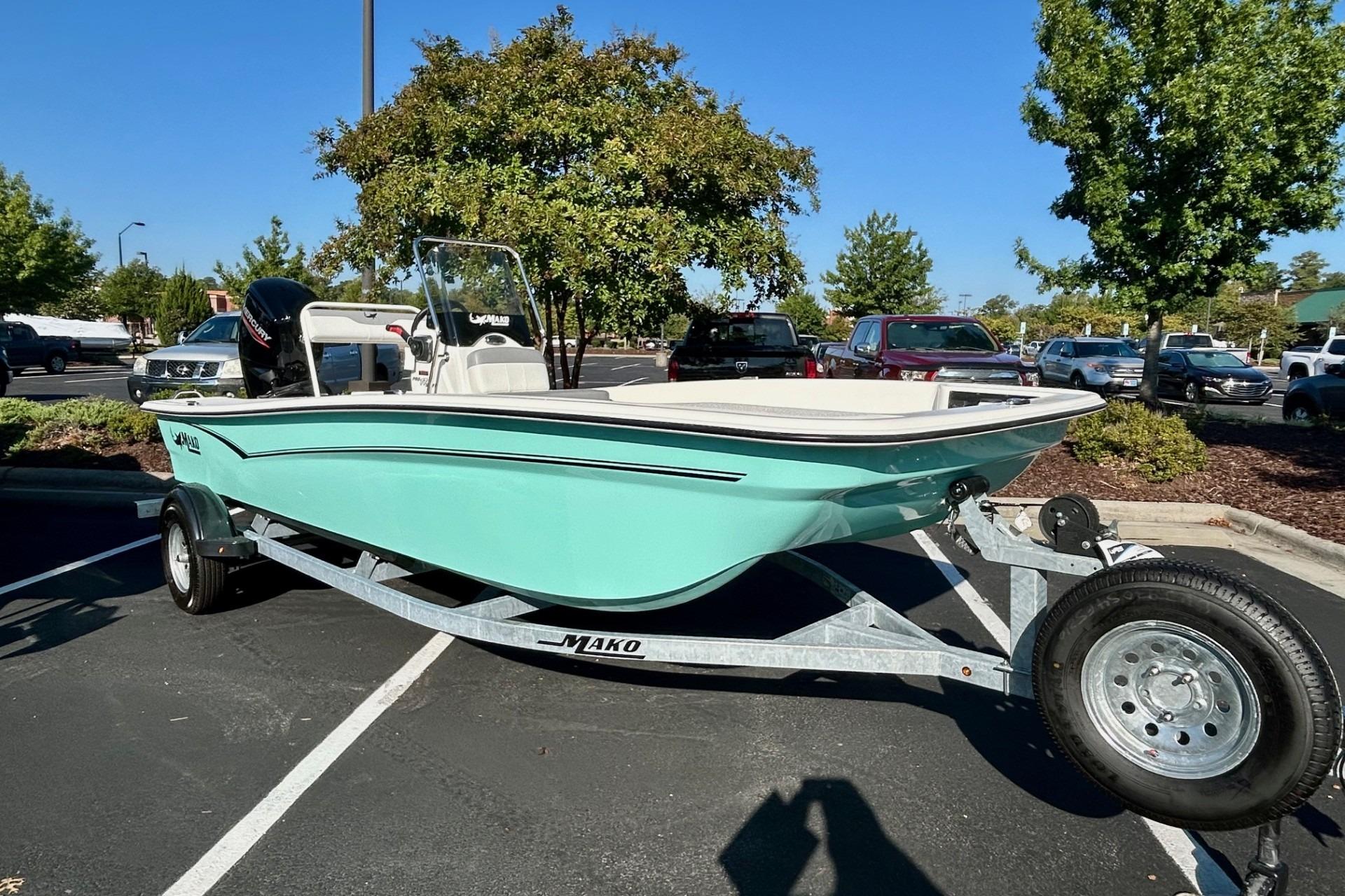 2026 Mako Pro Skiff 17 CC boat on trailer in parking lot, sunny day.