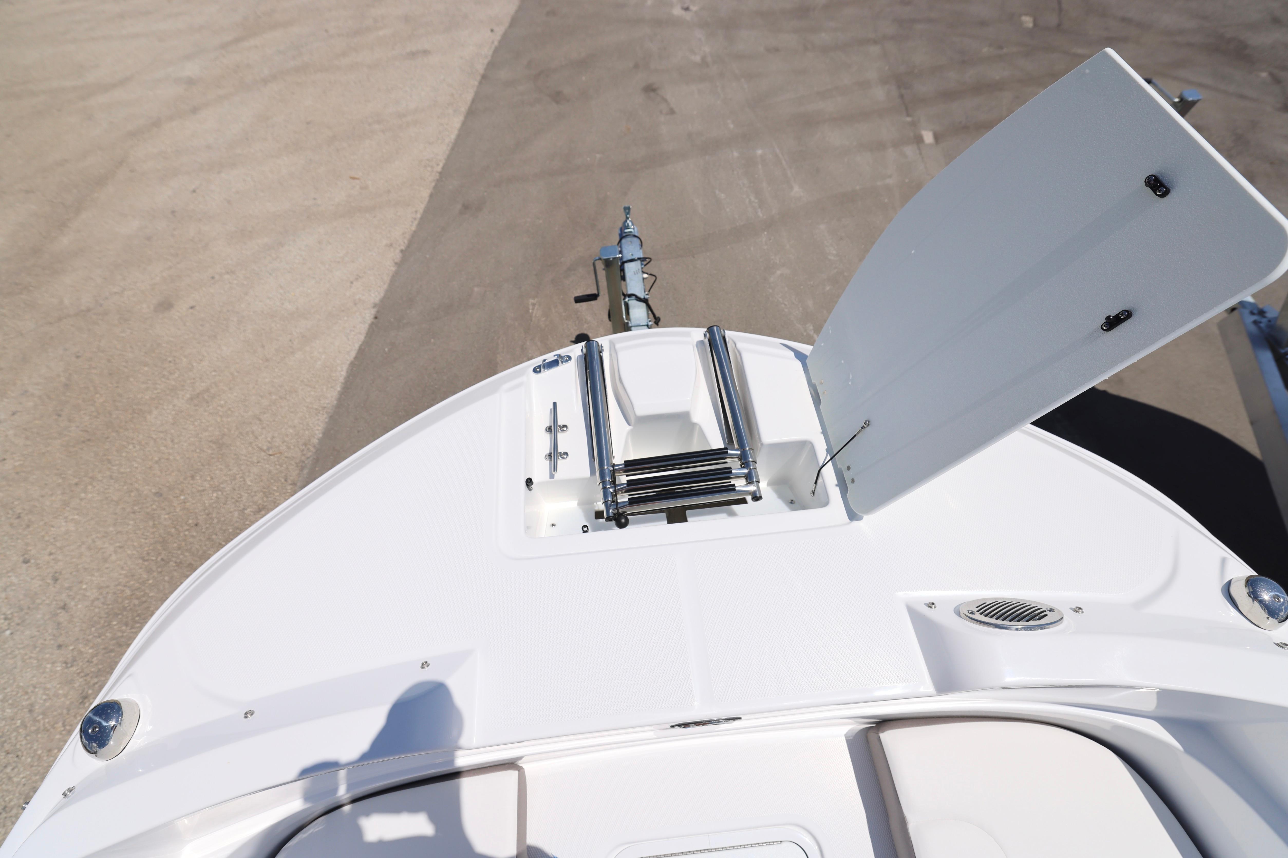 2026 Hurricane SunDeck Sport 205 OB boat with open storage compartment on deck.