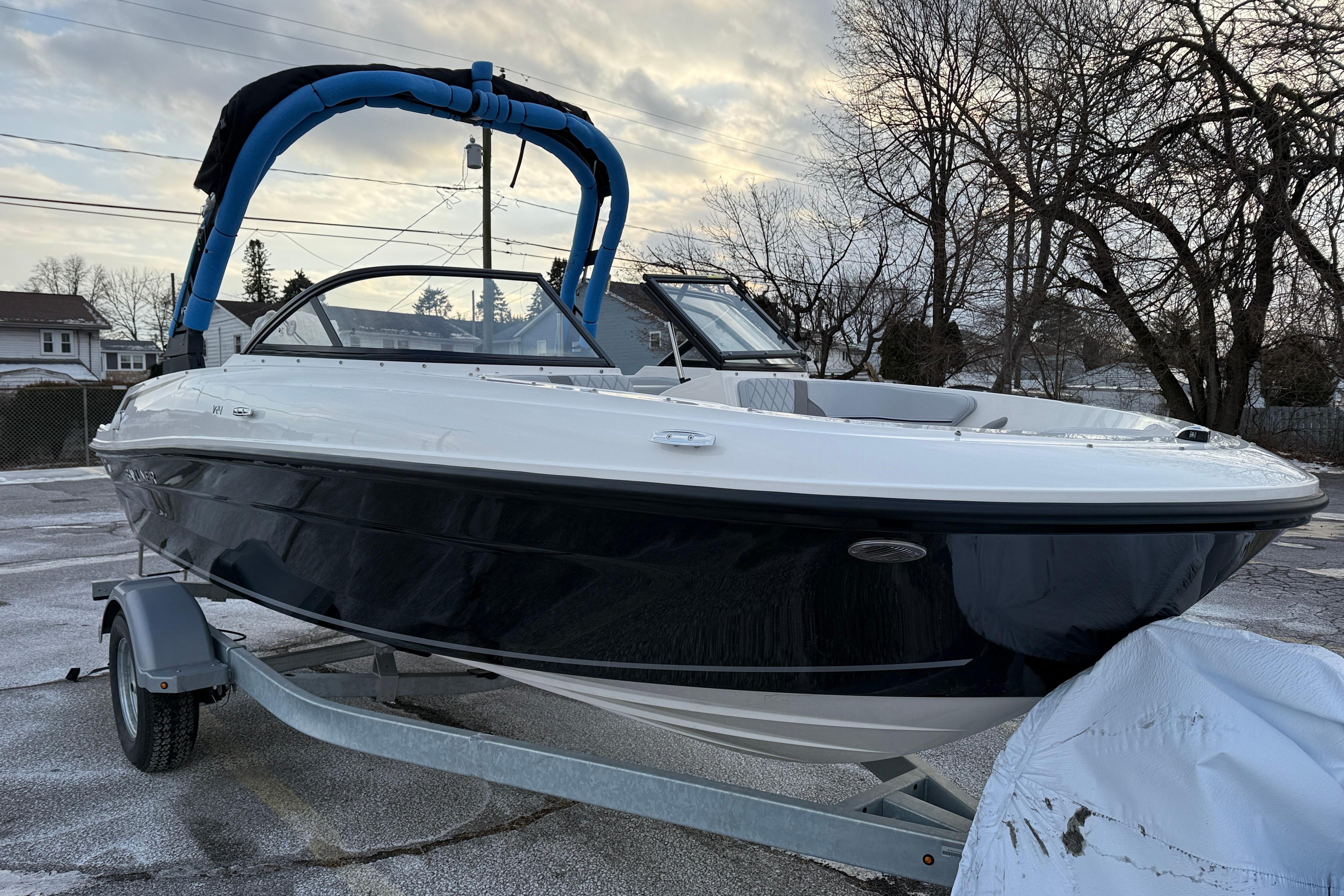 2026 Bayliner VR4 Bowrider OB on trailer, parked outdoors, overcast sky.