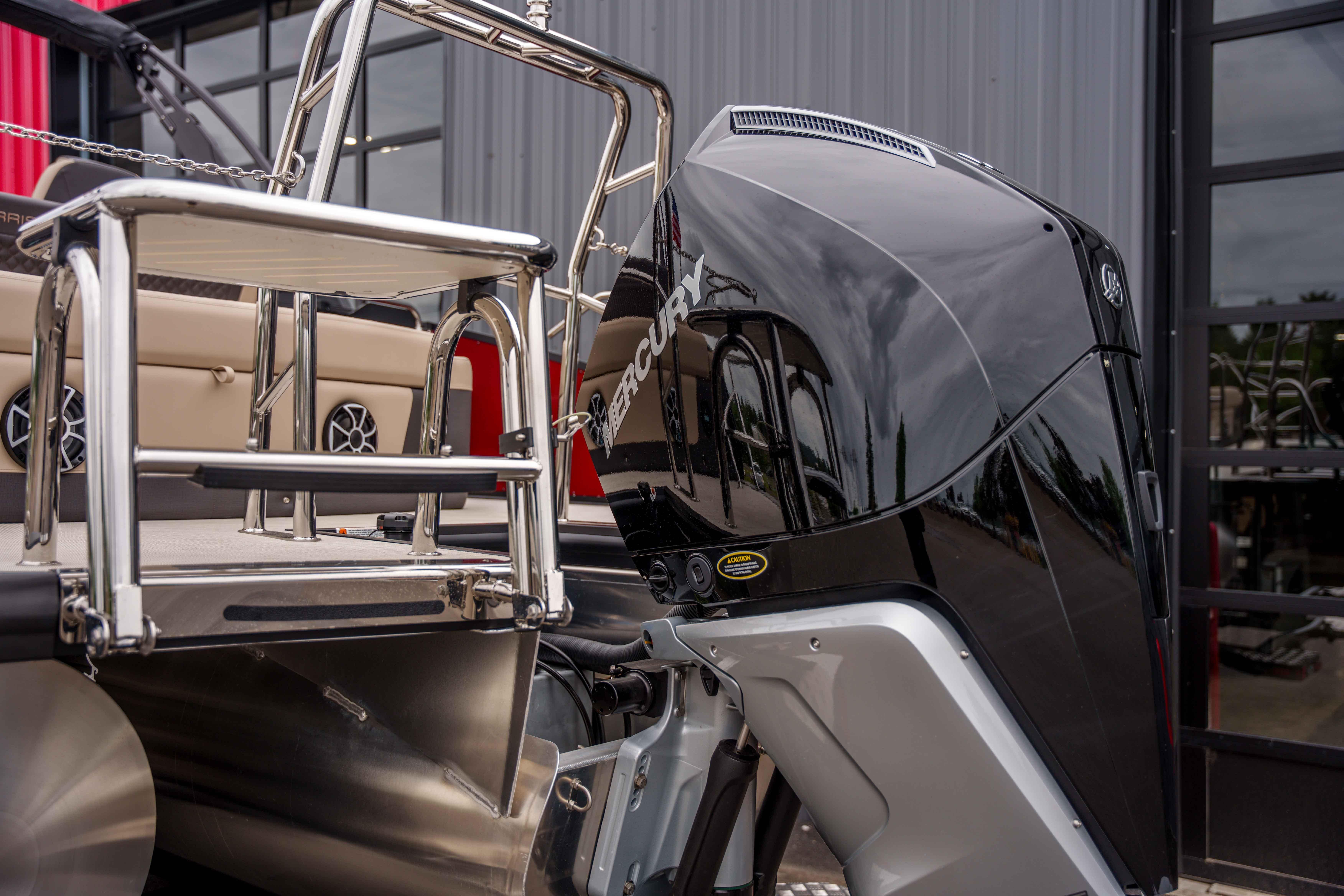 2026 Harris Sunliner 230 boat with Mercury outboard motor and stainless steel ladder.