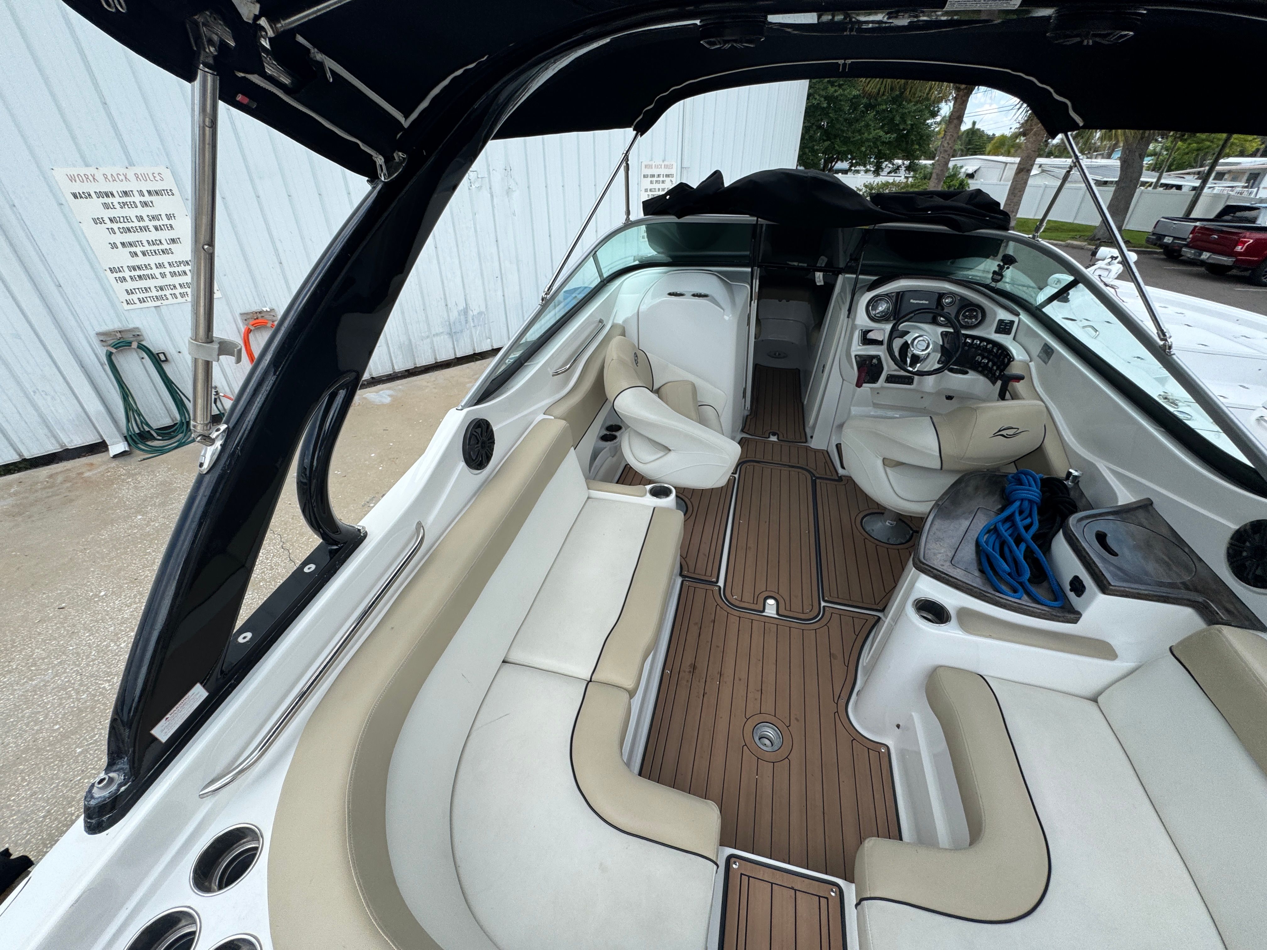 Interior of a 2017 Rinker QX29 BR boat with seating area.