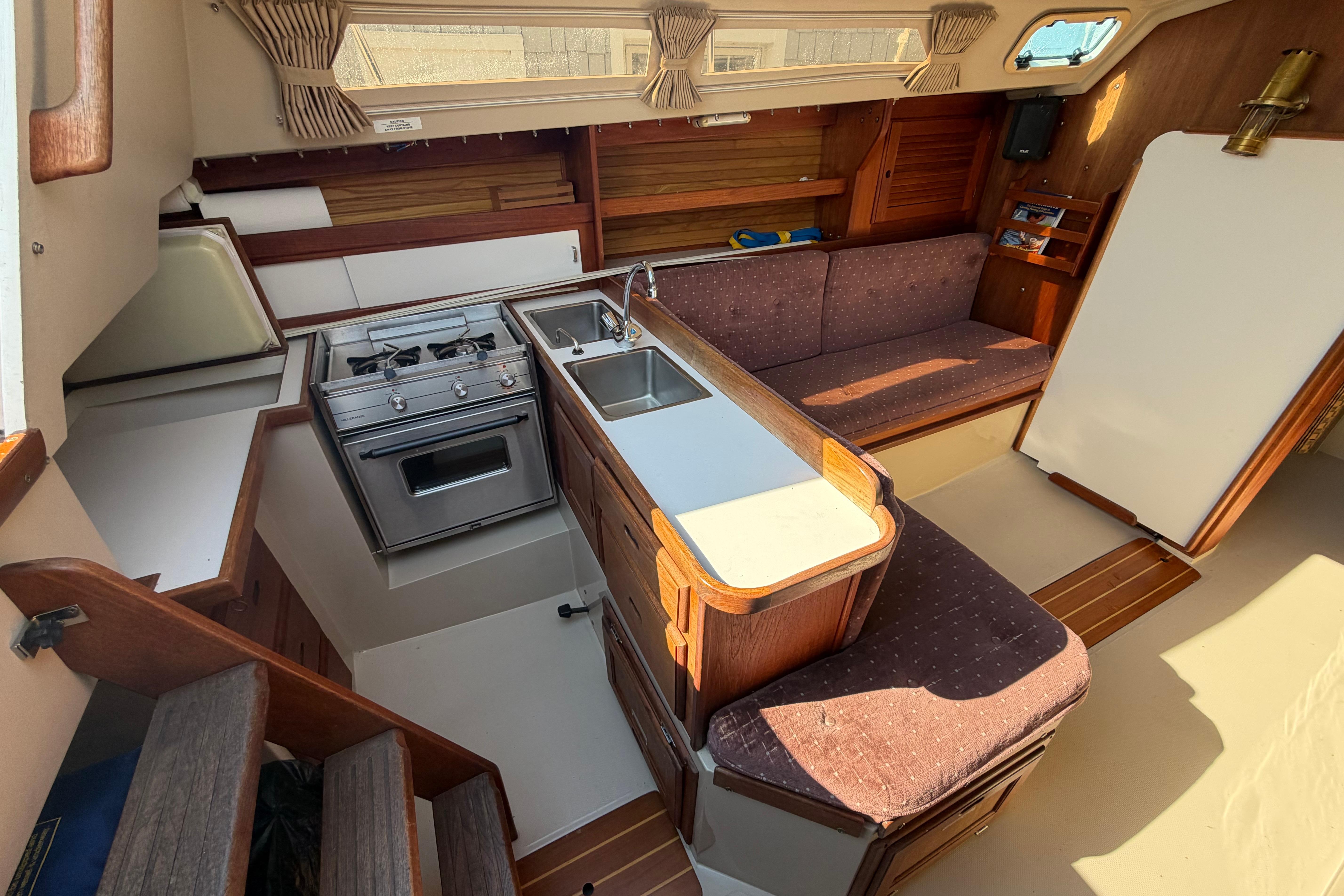 Interior of 1988 Catalina 30 MkII sailboat with kitchen and seating area.