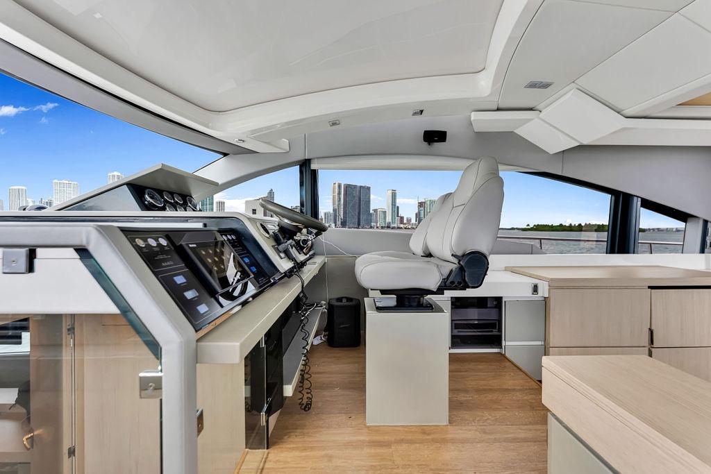 Luxurious helm of 2012 Fairline Targa 58 yacht with city skyline view.