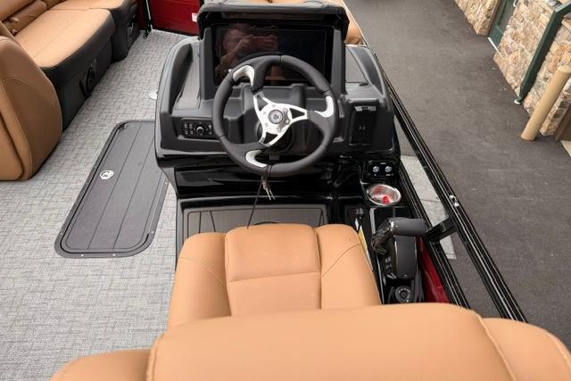 2026 Regency 230 DL boat interior with tan seating and modern steering console.