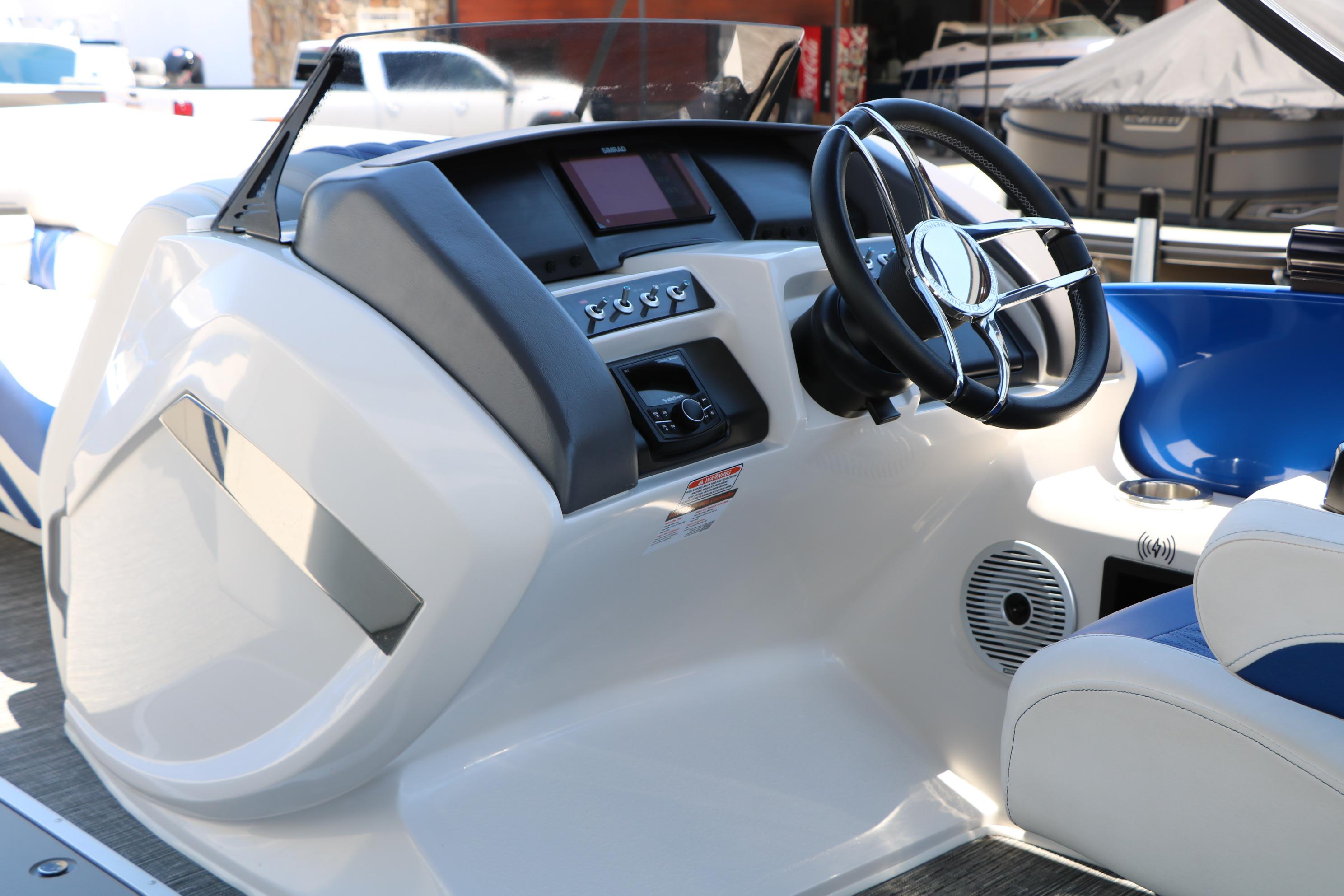 2024 Bennington 23 RX Swingback boat dashboard with steering wheel and controls.