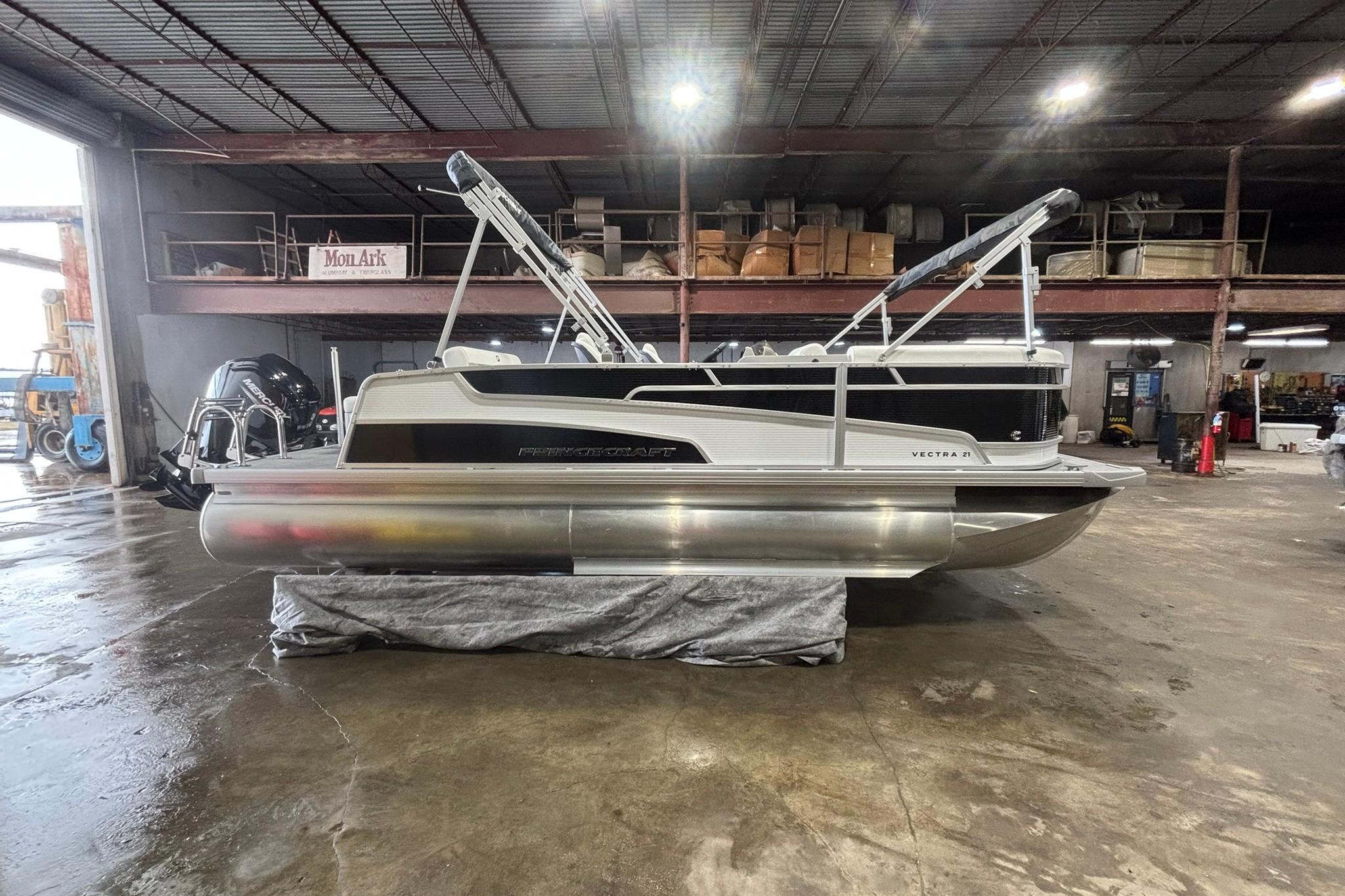 2025 Princecraft Vectra 21 RL pontoon boat in a warehouse setting.