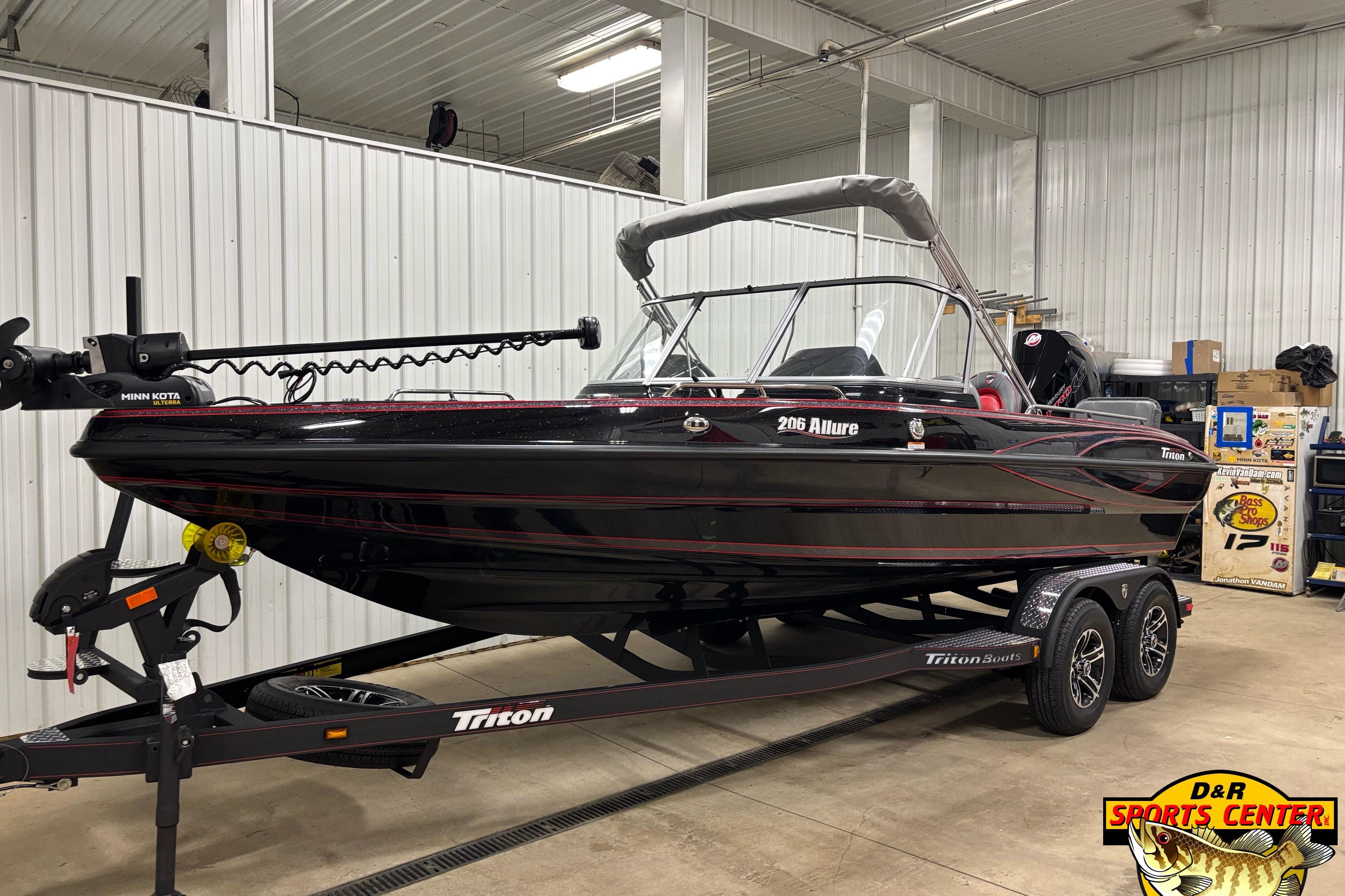 2026 Triton 206 Allure boat on trailer in indoor showroom.