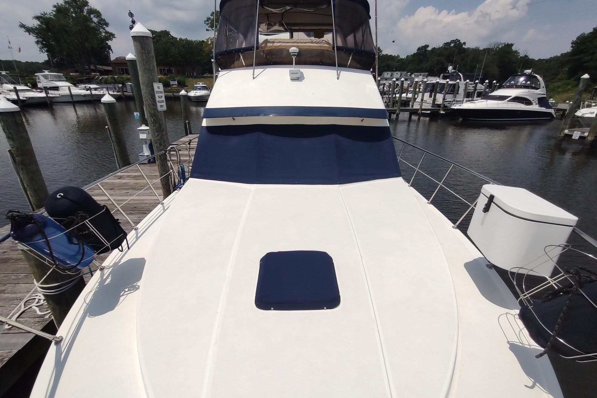 1989 Hyatt Double Cabin Motoryacht docked at marina, featuring spacious deck and sleek design.