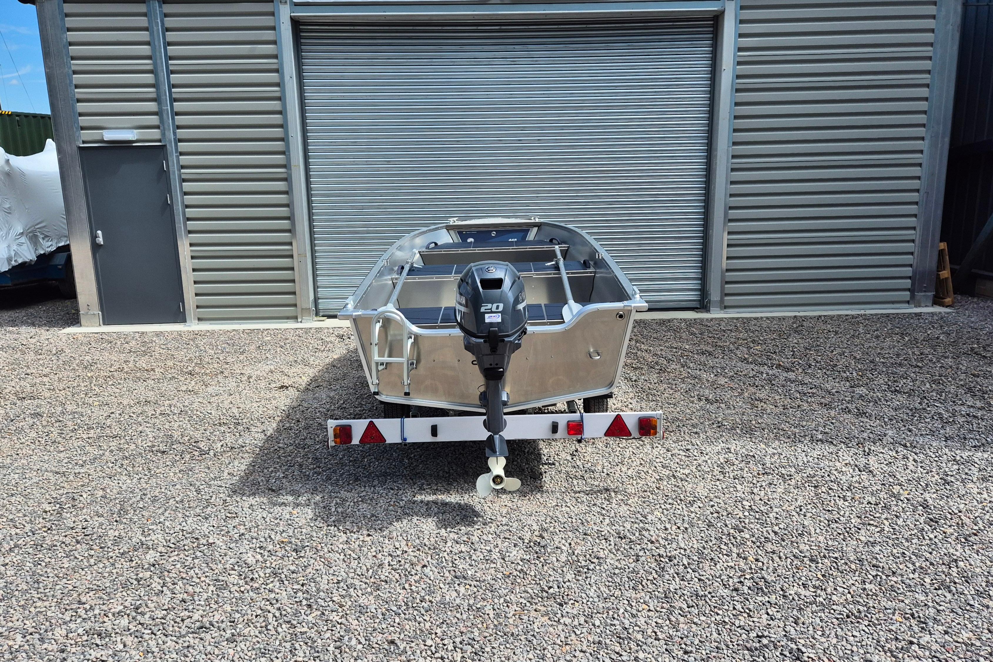 2026 Linder Sportsman 445 Basic boat on trailer, parked outside a metal building.