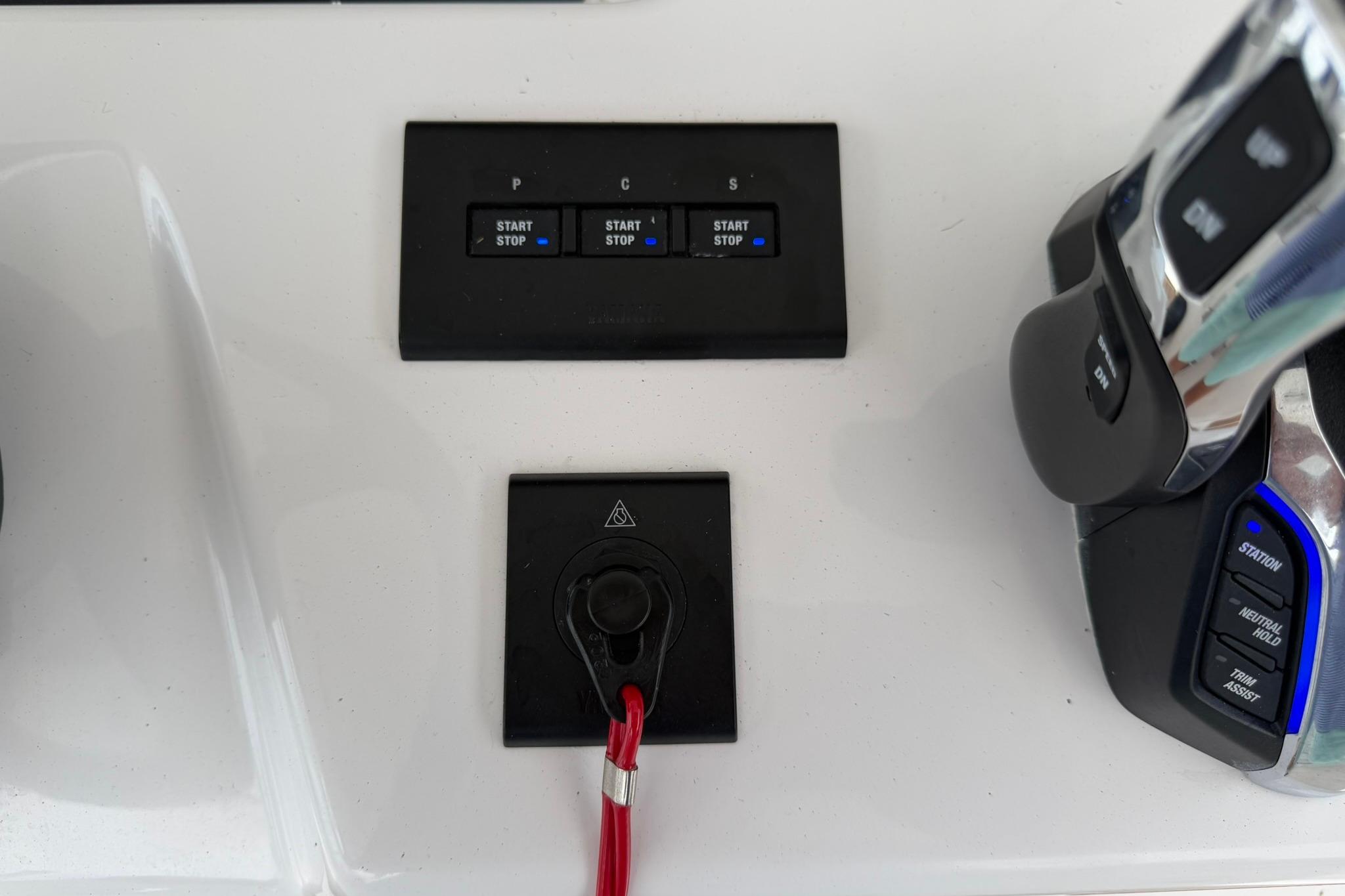 Control panel of a 2026 Regulator 37 boat with start/stop buttons and throttle.