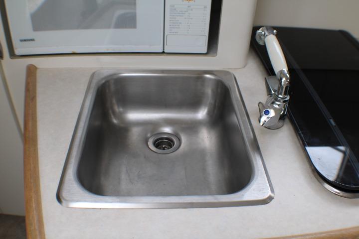 Stainless steel sink in 1998 Bayliner 2655 Ciera Sunbridge boat kitchen area.
