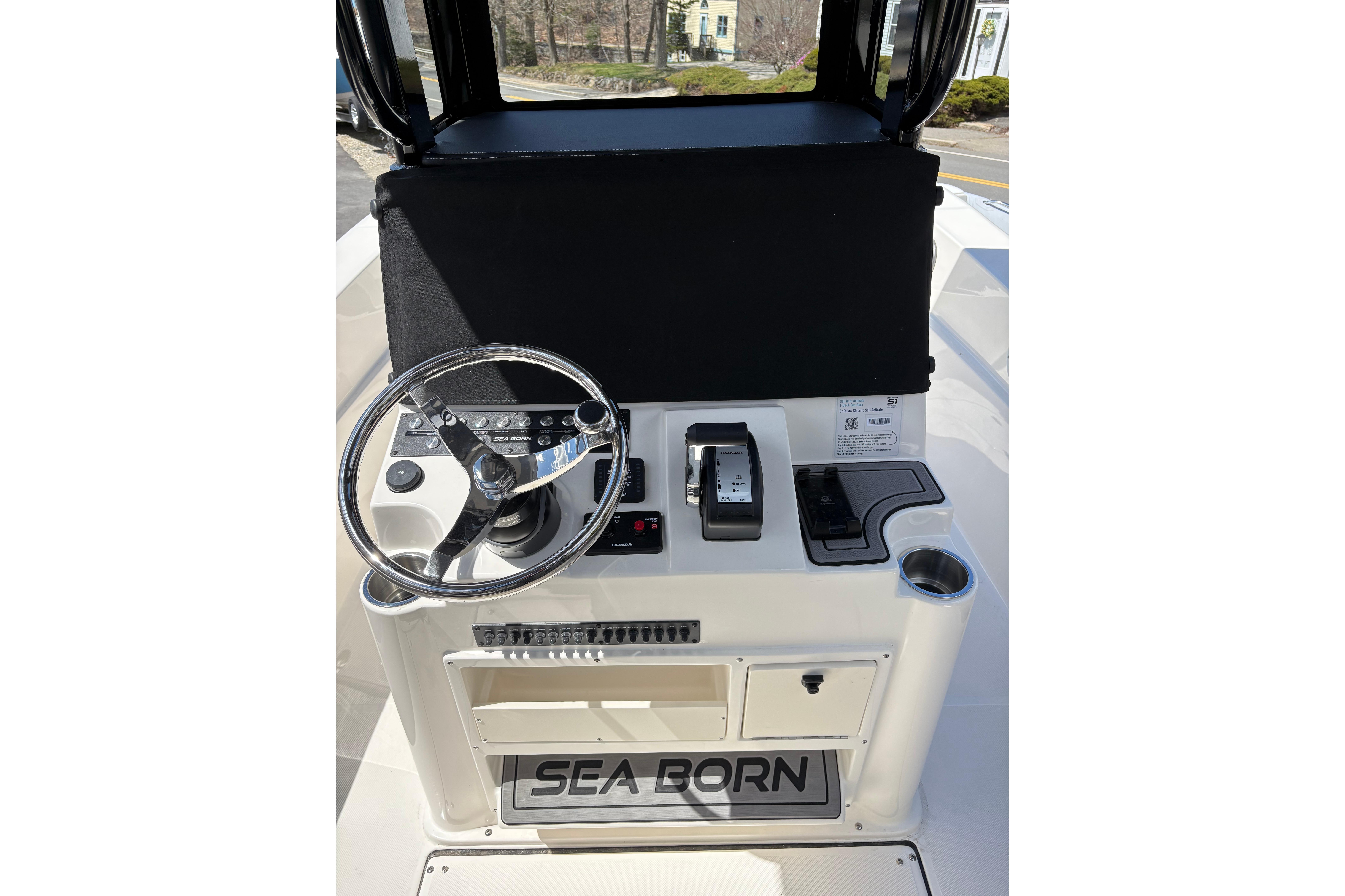 2026 Sea Born LX24 Center Console helm with steering wheel and controls.