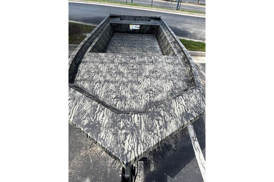 2026 Tracker Grizzly 1860 Utility boat with camouflage pattern, parked outdoors.