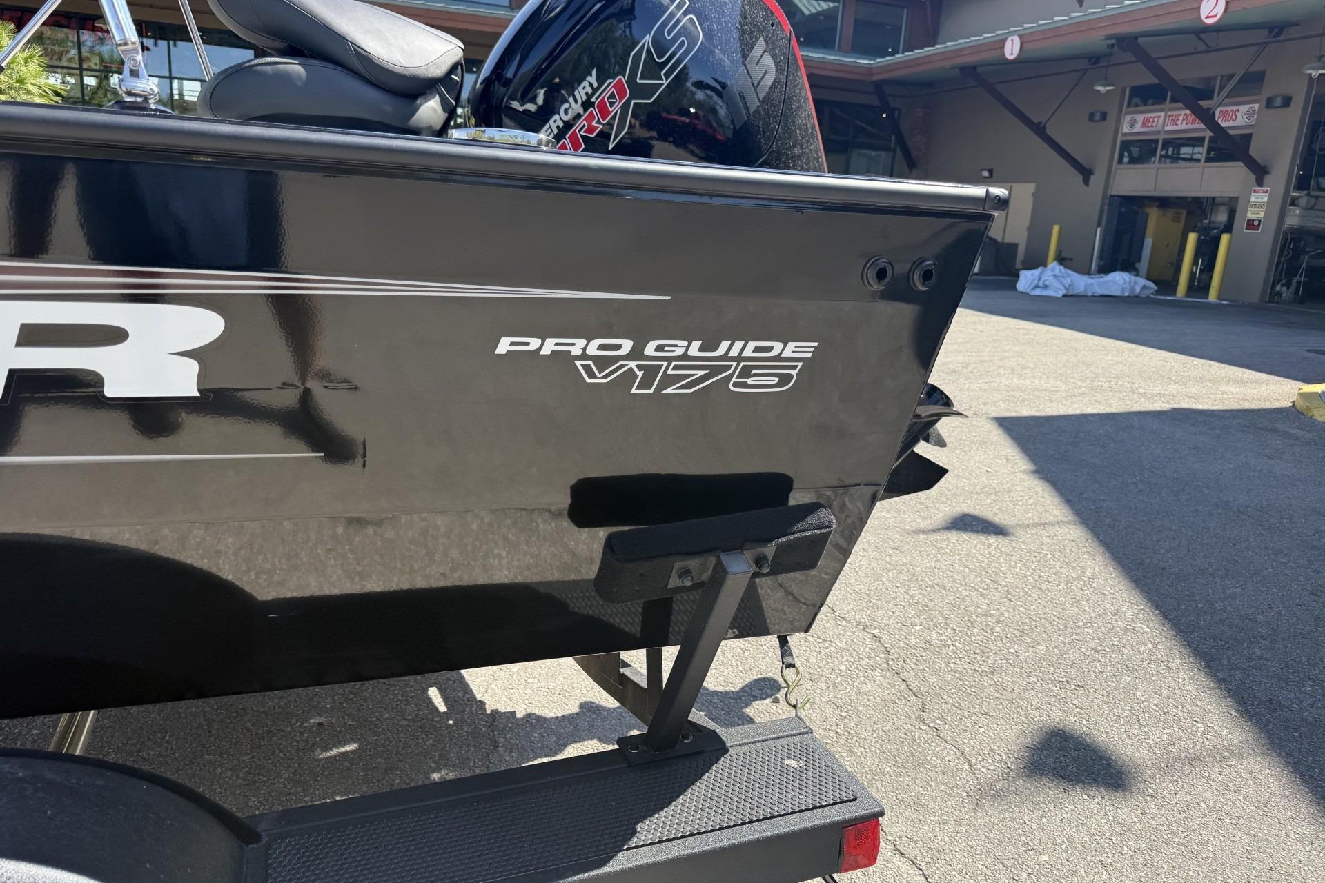 2026 Tracker Pro Guide V-175 Combo boat rear view in outdoor setting.