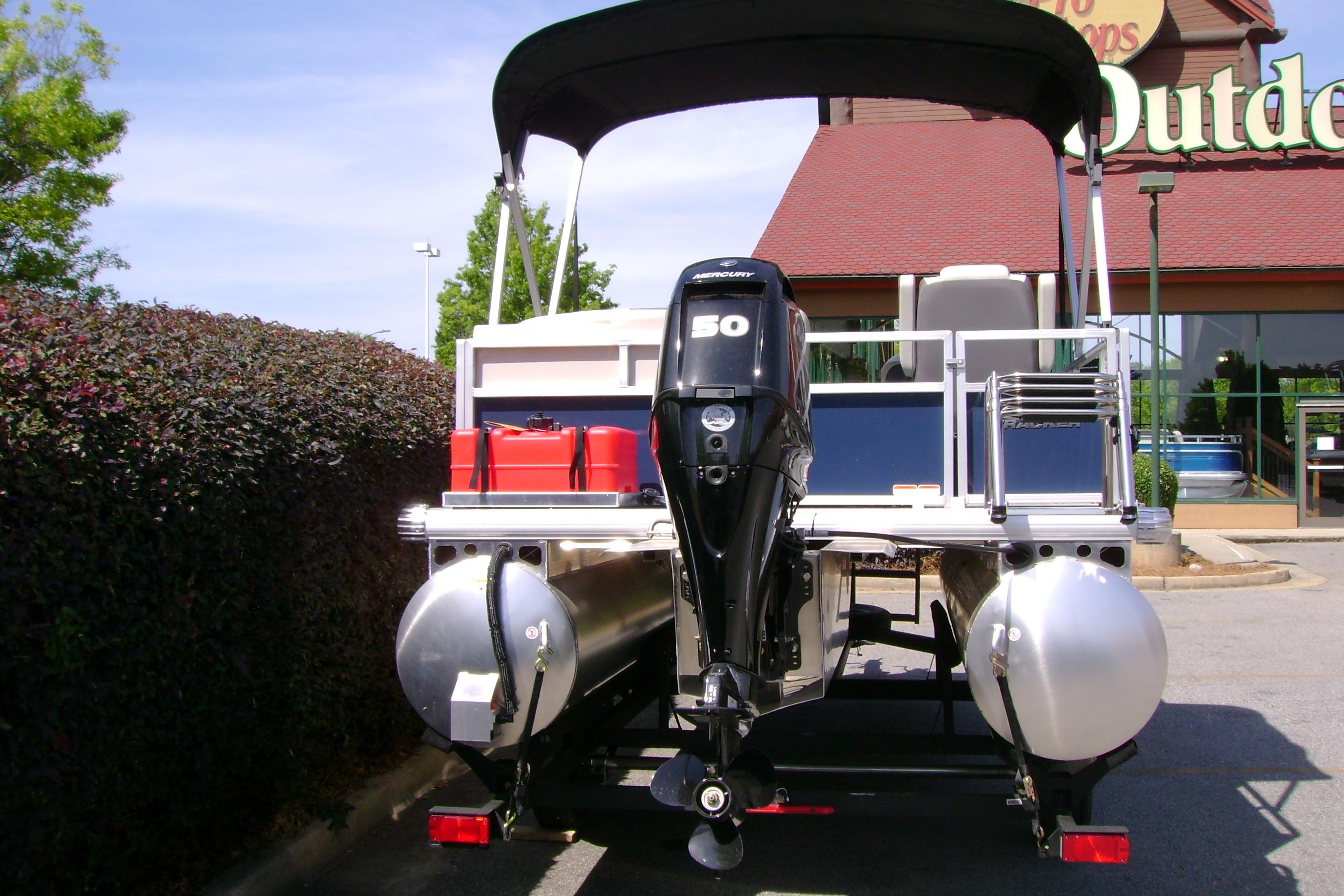 2026 Sun Tracker Bass Buggy 16 XL Select pontoon boat with Mercury 50 engine, parked outdoors.