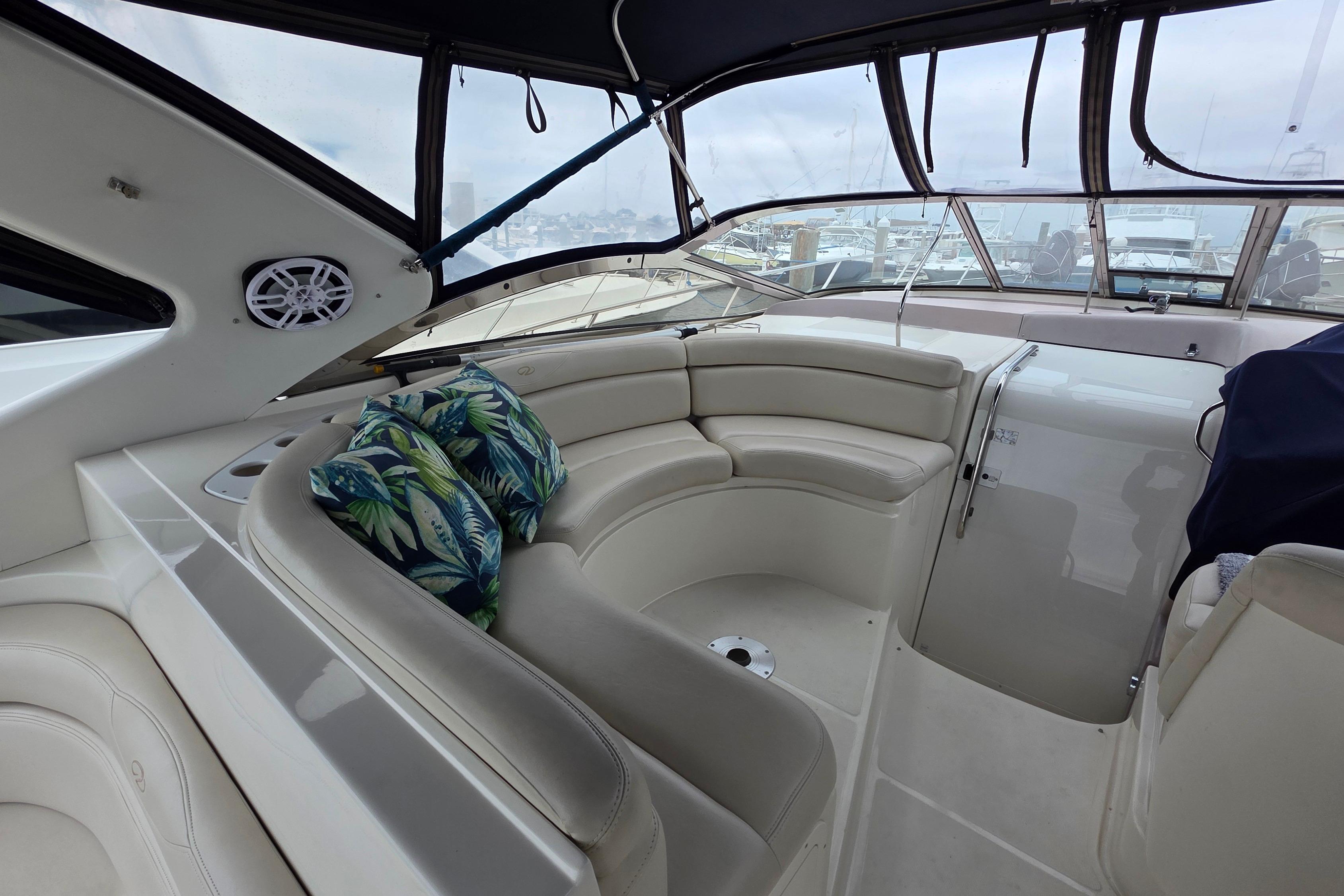 Luxurious 2002 Regal Commodore 4260 yacht interior with plush seating and tropical cushions.