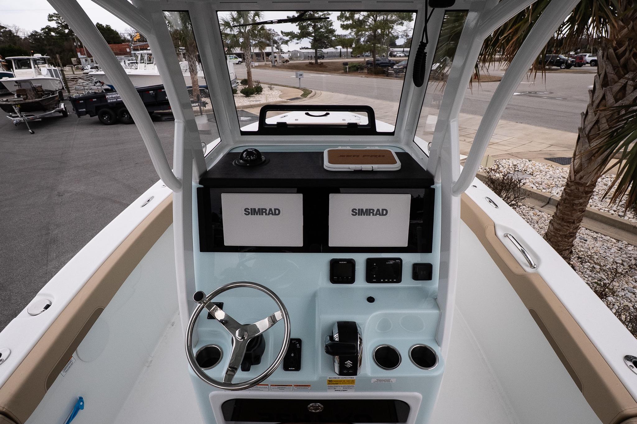 2026 Sea Pro 245FLXR Sandbar boat console with Simrad displays and steering wheel.