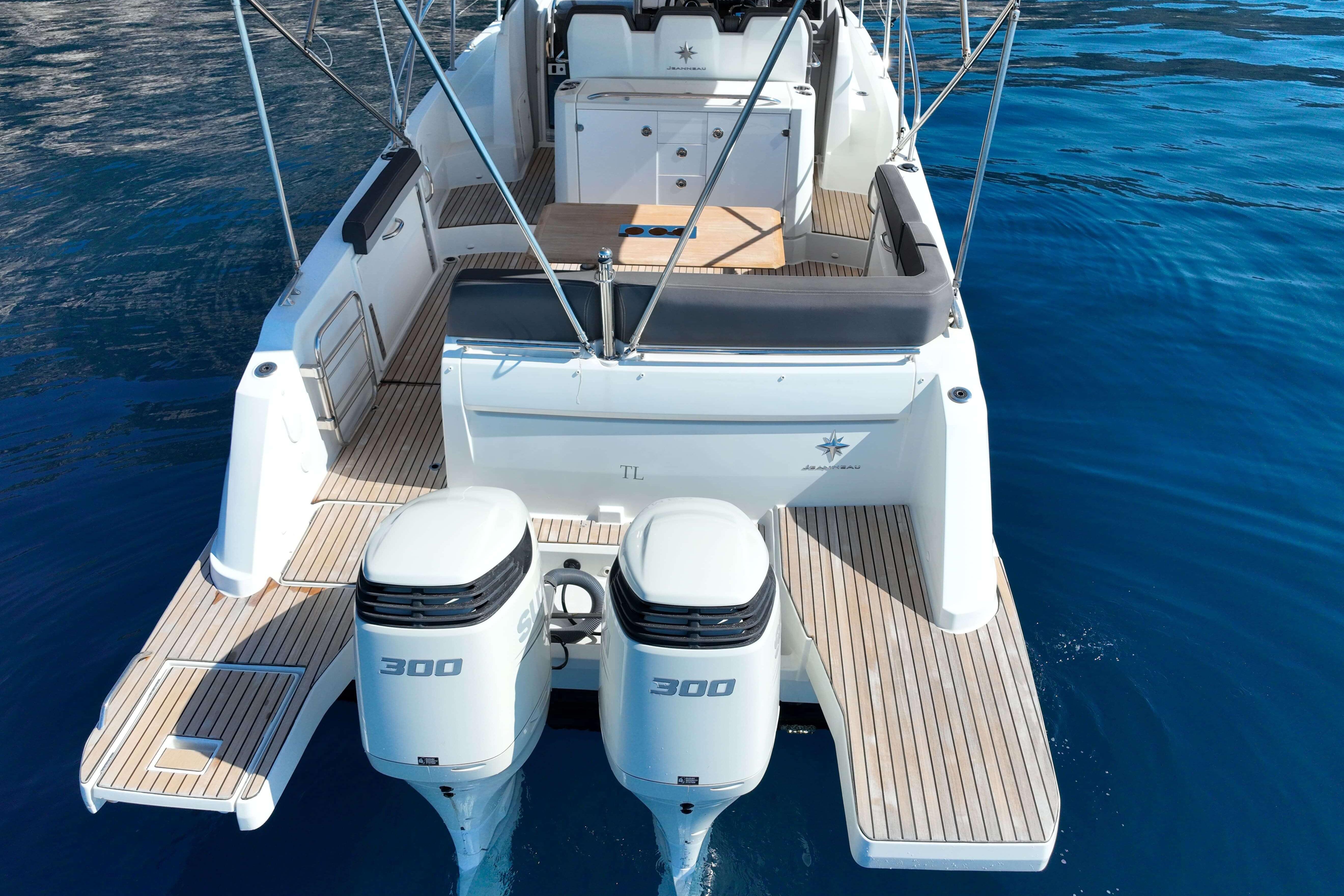 2018 Cap Camarat 10.5 WA boat with twin 300 horsepower engines on clear blue water.