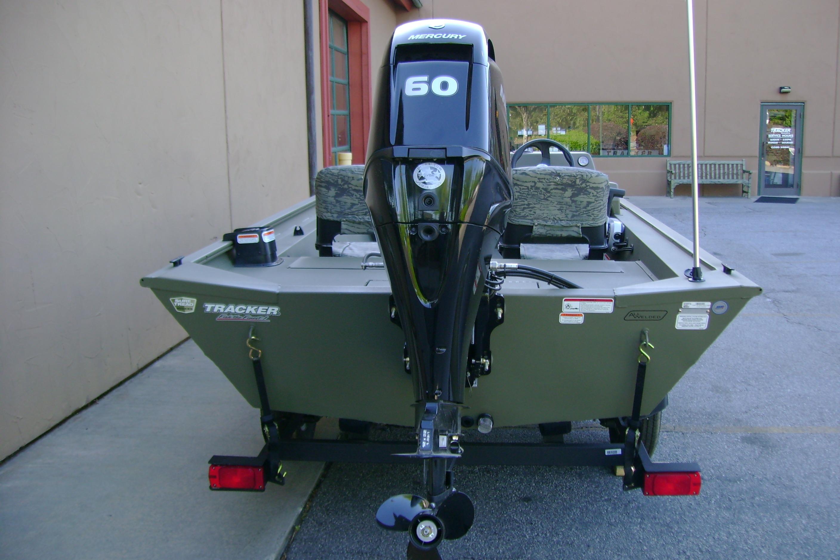 2026 Tracker Grizzly 1754 SC boat with Mercury 60 engine, parked outdoors.