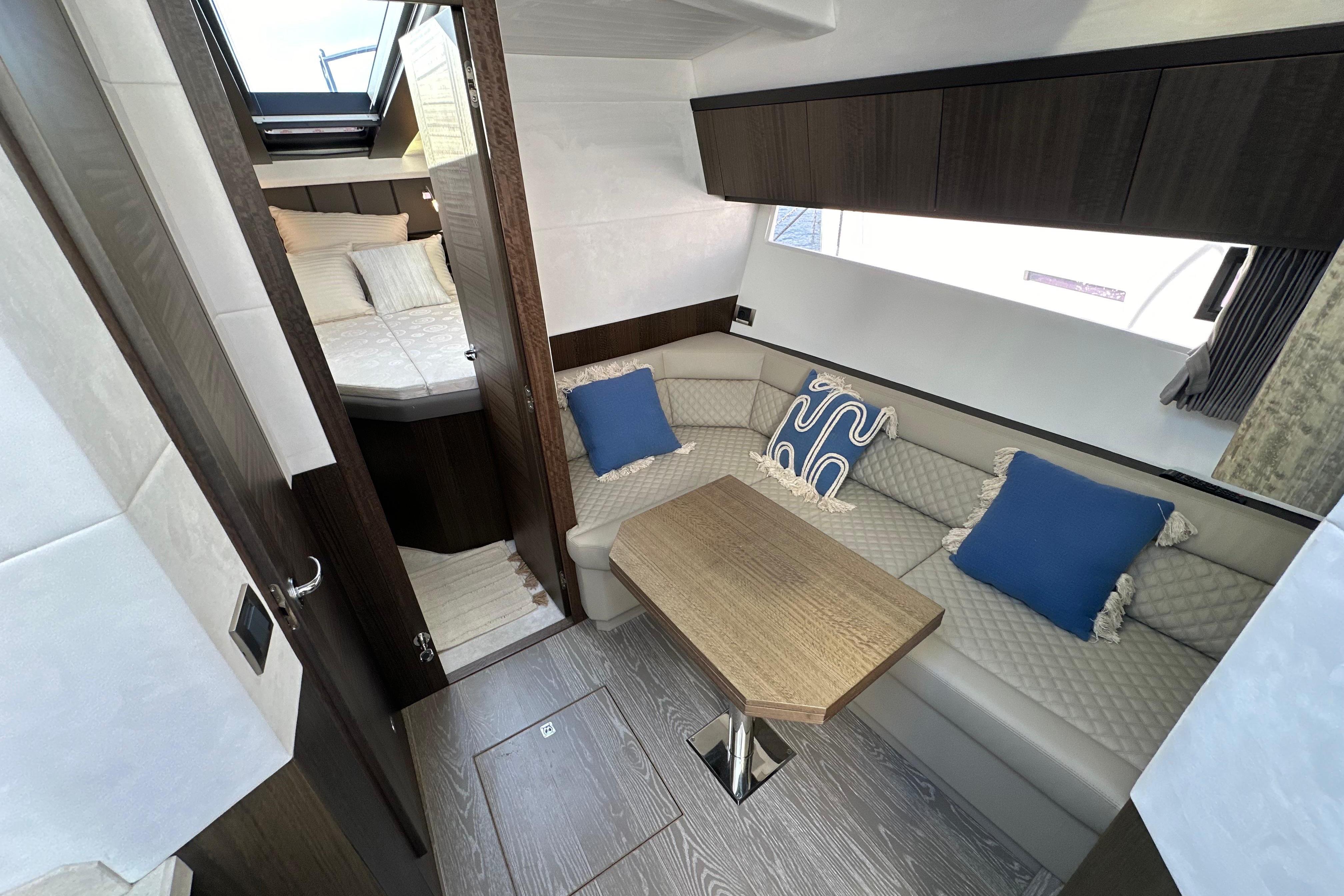 2018 Galeon 425 HTS yacht interior with cozy seating, wooden table, and elegant decor.
