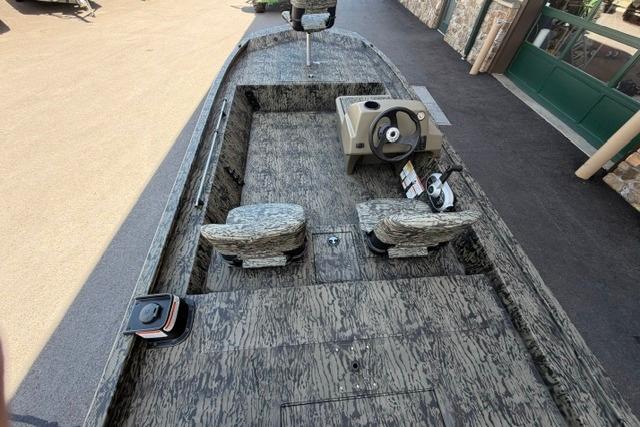 2026 Tracker Grizzly 1754 SC boat with camouflage interior and steering console.