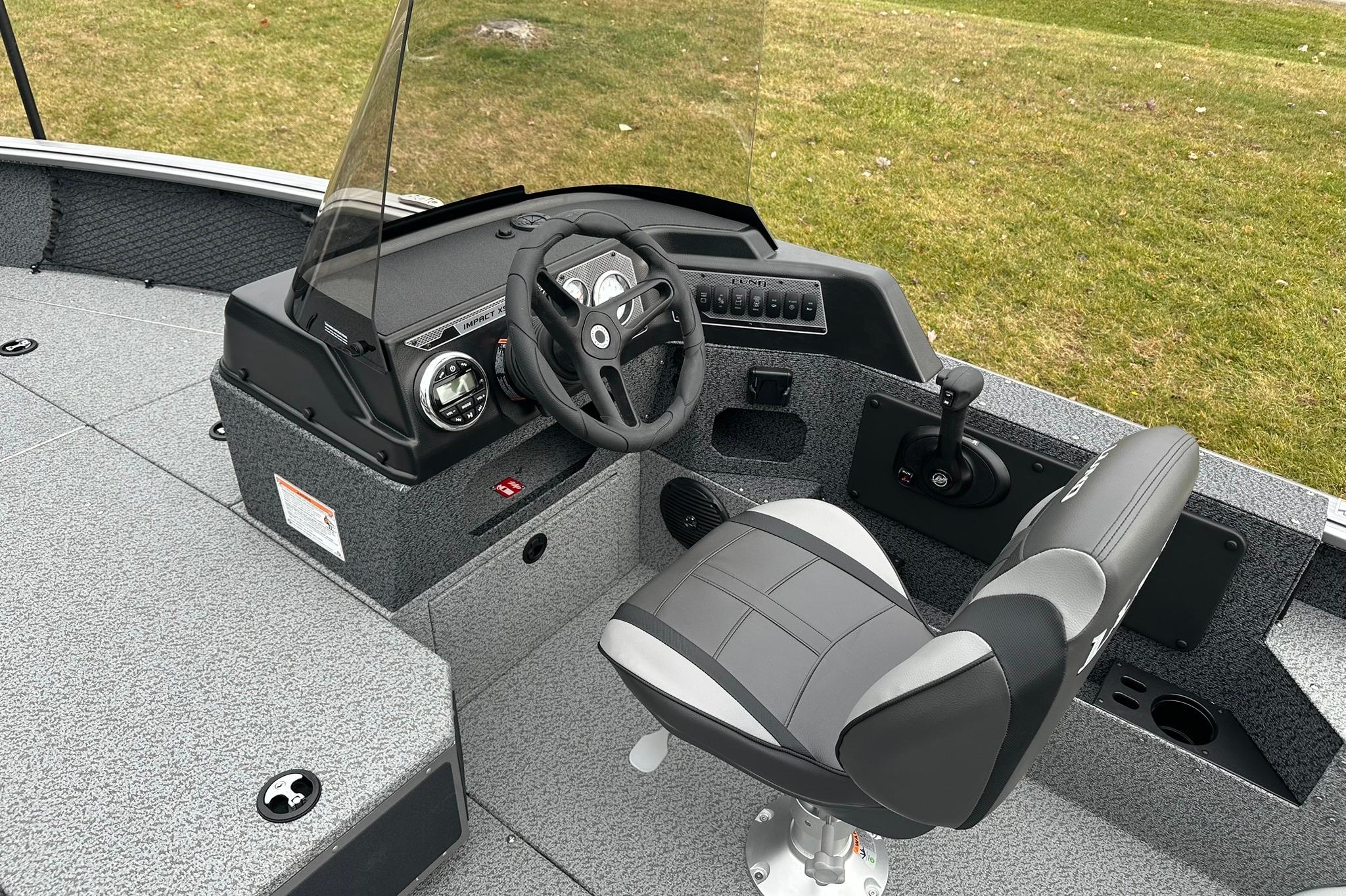 2026 Lund 1875 Impact XS SS boat interior with steering console and seat.