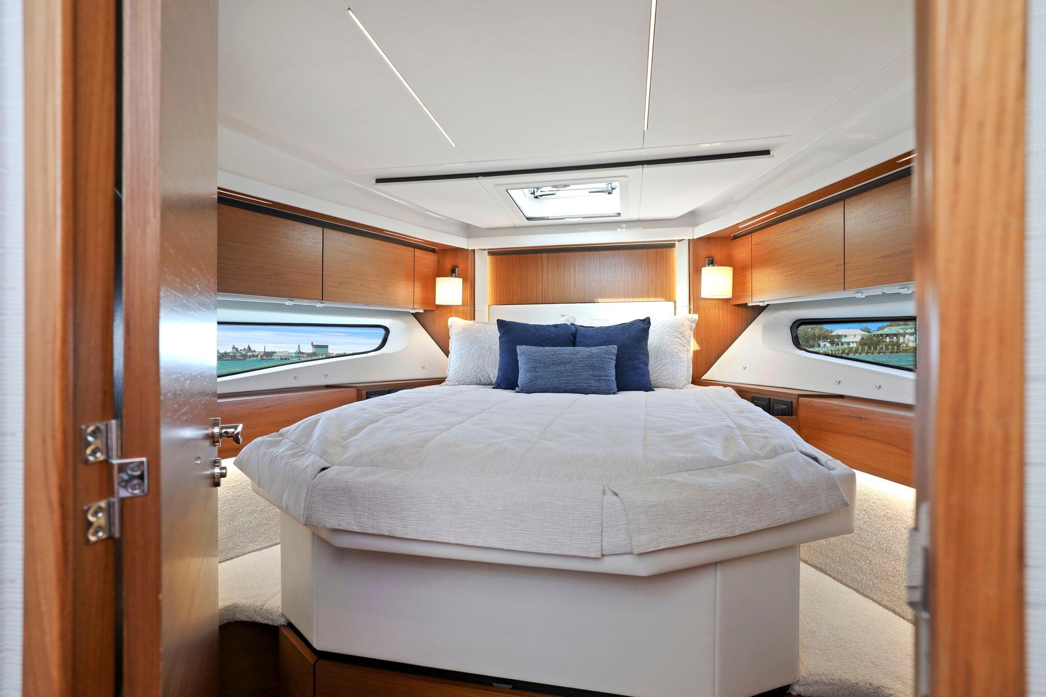 Luxurious bedroom interior of 2023 Tiara Yachts C49 Coupe with elegant wood finishes.