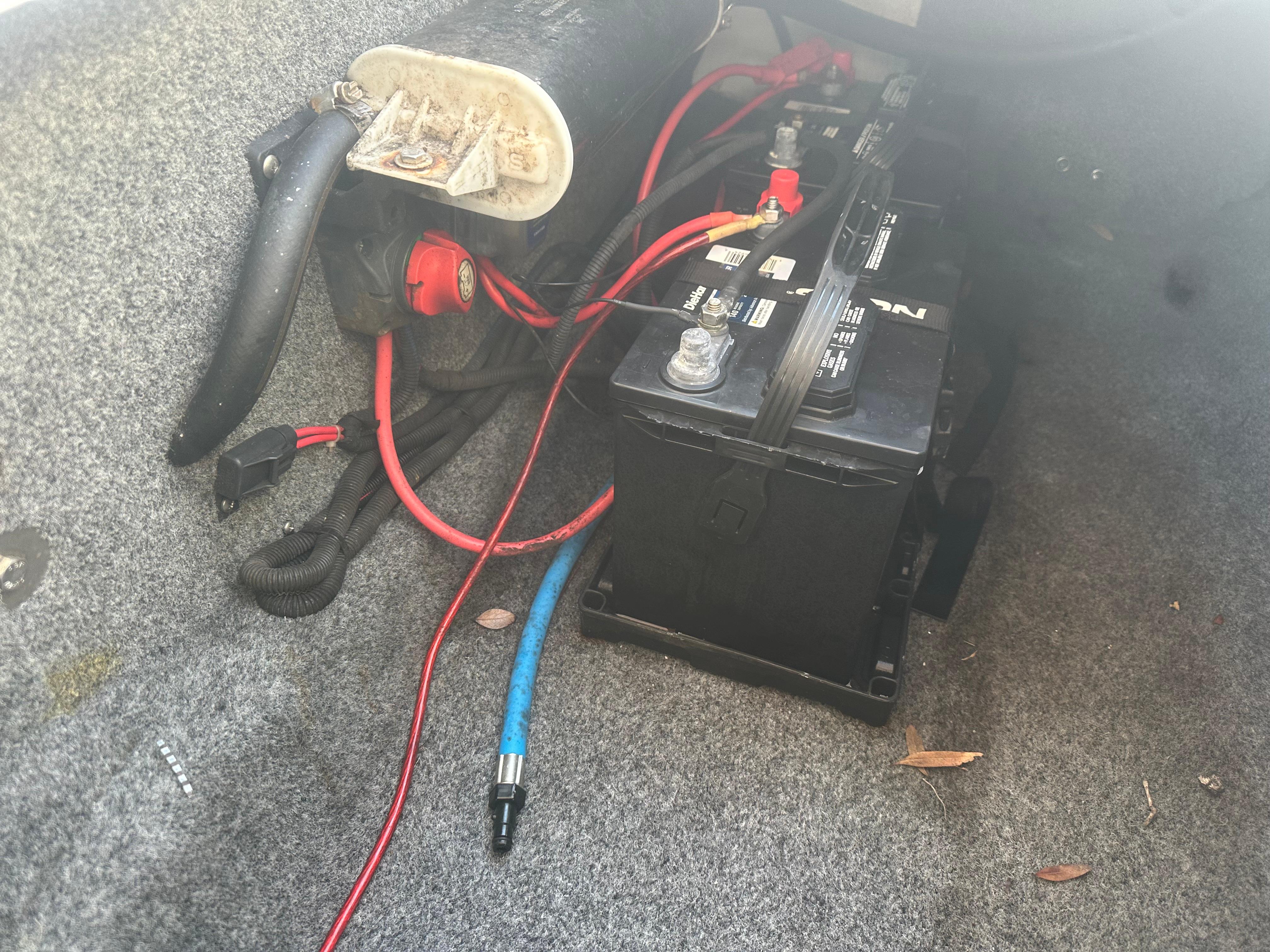 Battery compartment of 2013 Yamaha Boats SX192 with wiring and tools.