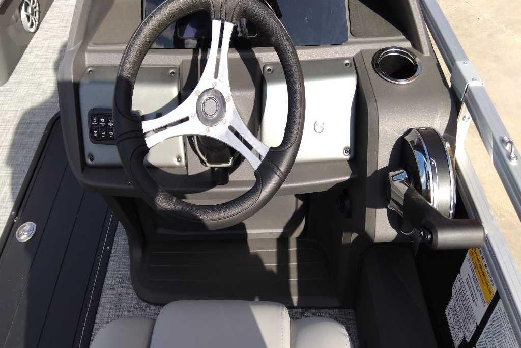 2026 Sun Tracker SportFish 22 XP3 steering console with modern controls and cup holder.