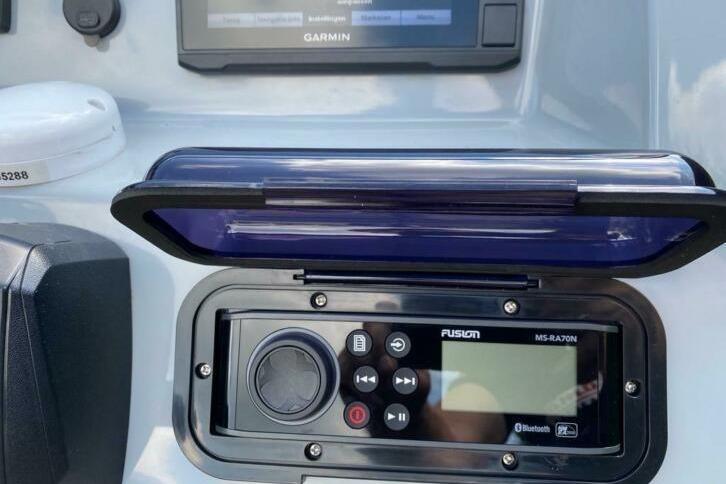 Control panel of a 2018 Infanta 7.5 SR boat with Garmin and Fusion systems.