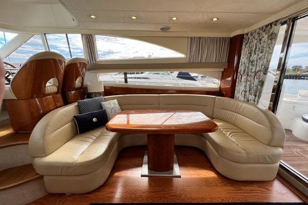 Luxurious interior of 2003 Viking Princess 50 Sport Cruiser with elegant seating and wooden table.