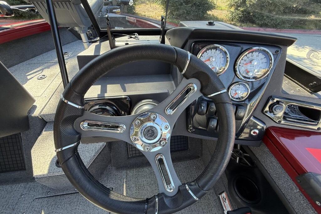 Steering wheel and dashboard of 2024 Tracker Targa V-19 WT boat, featuring gauges and controls.