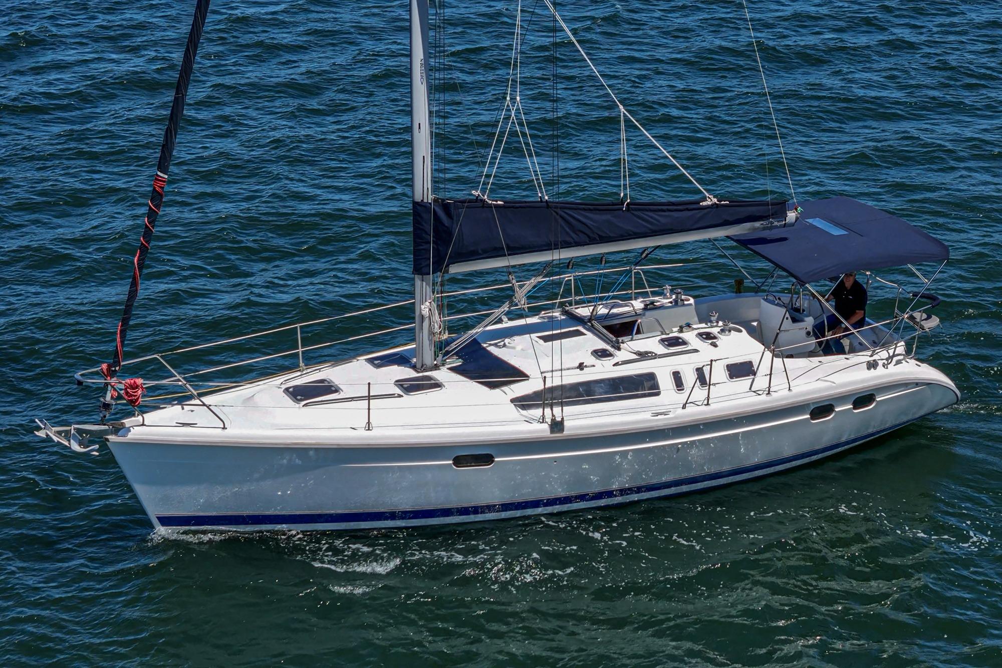 Hunter 376 sailboat from 1996 cruising on open water, featuring sleek design and spacious deck.