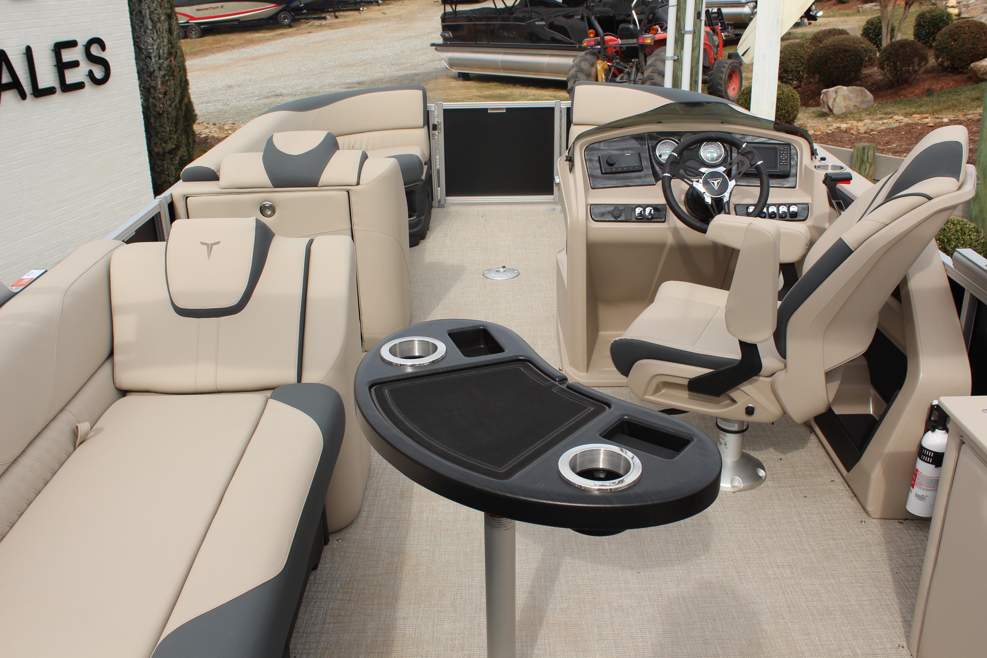 2026 Tahoe Pontoon LTZ interior with beige seating and modern helm.